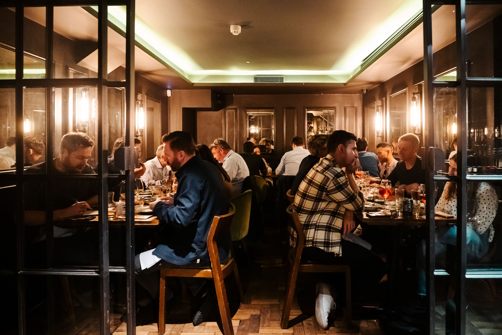 Private dining room at Ember Yard with warm lighting, ideal for networking events and dinners.