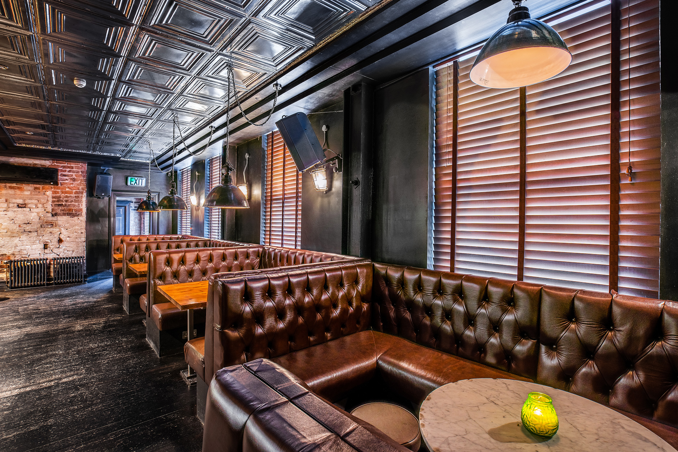 Stylish venue with leather booths, ideal for networking events and gatherings.