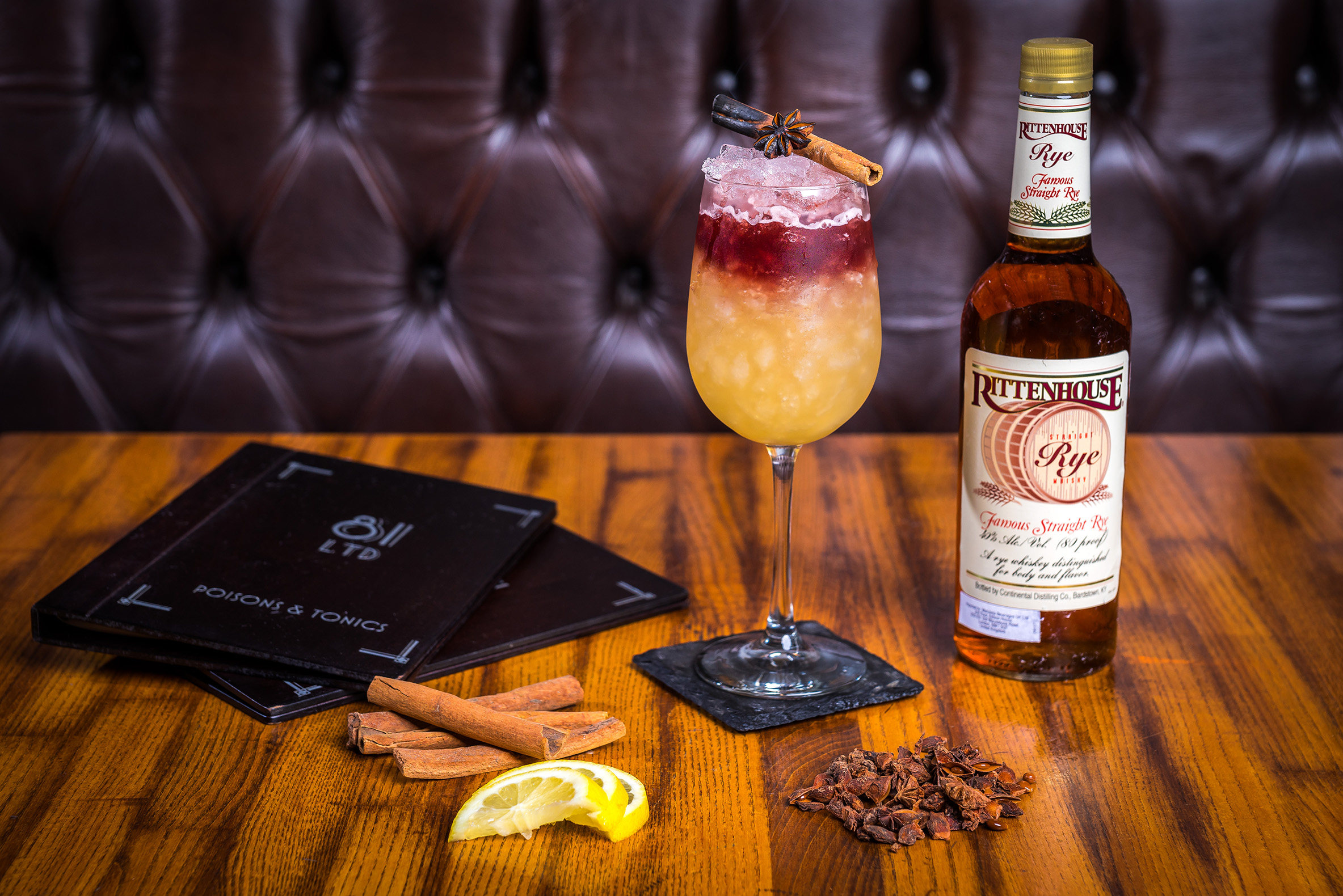 Cocktail presentation with cinnamon stick and lemon slice for themed parties and receptions.