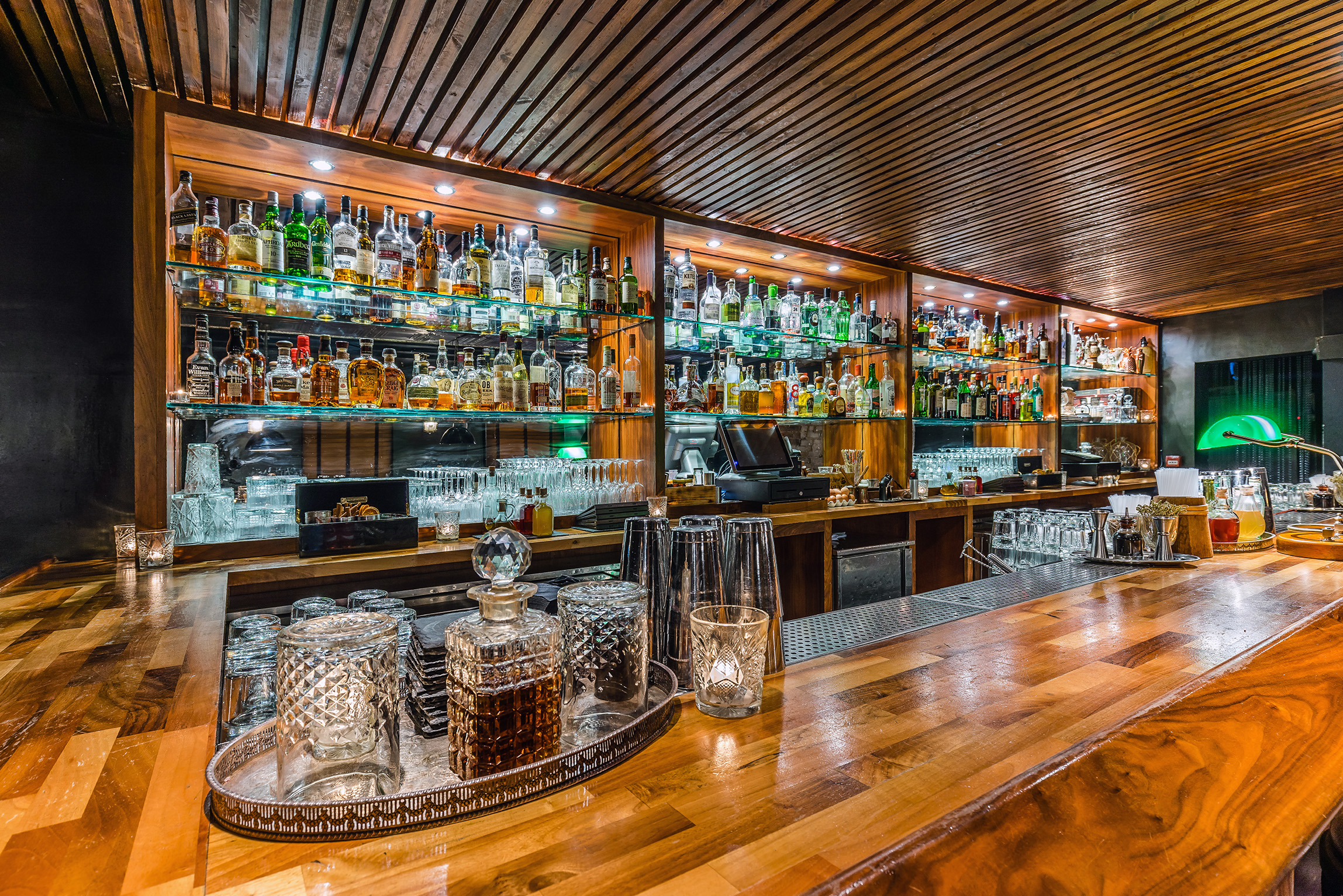 Elegant wooden bar with spirits, ideal for networking events and cocktail receptions.