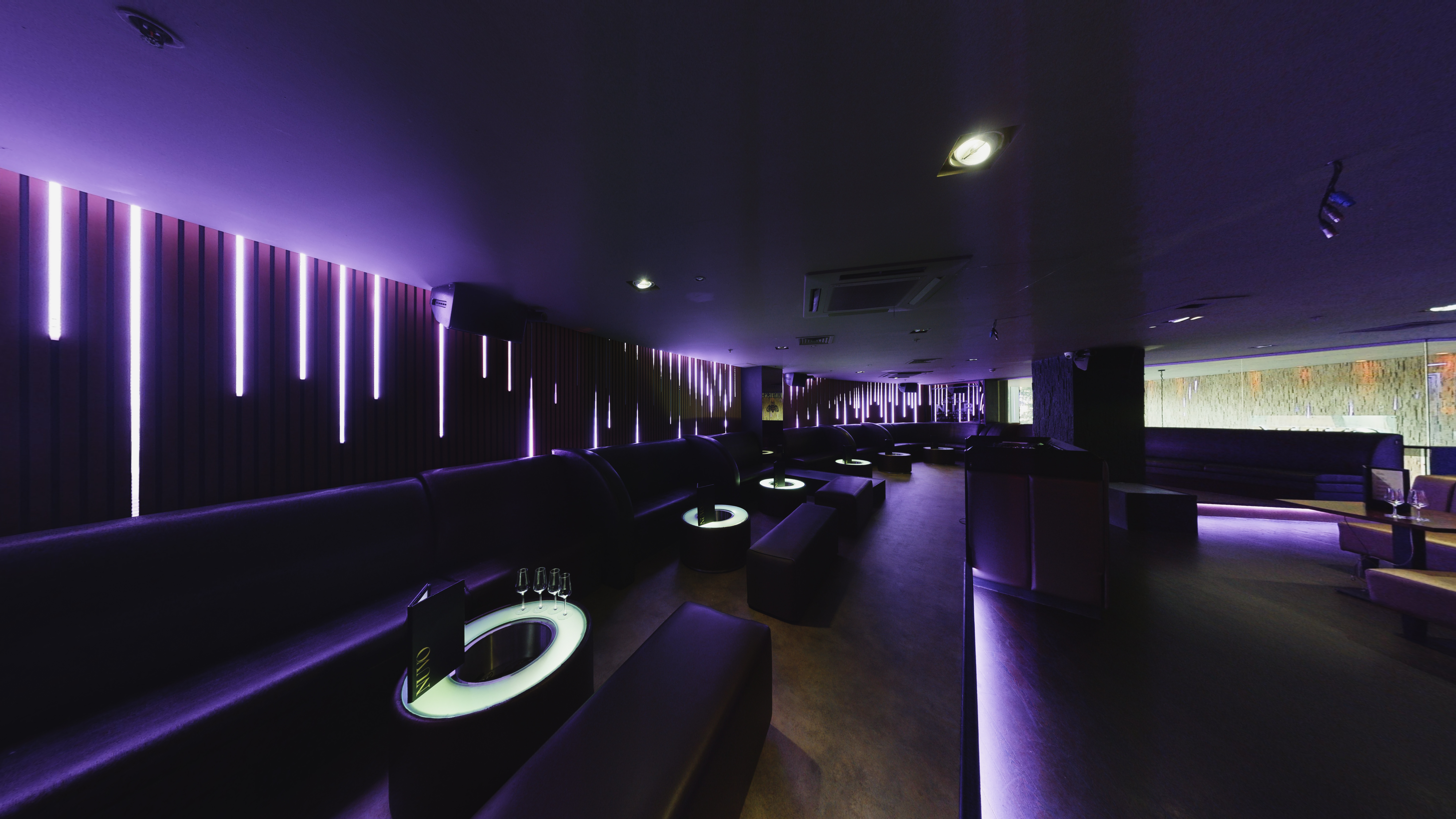 Sleek Nuvo Late Lounge with purple lighting, perfect for networking events and gatherings.
