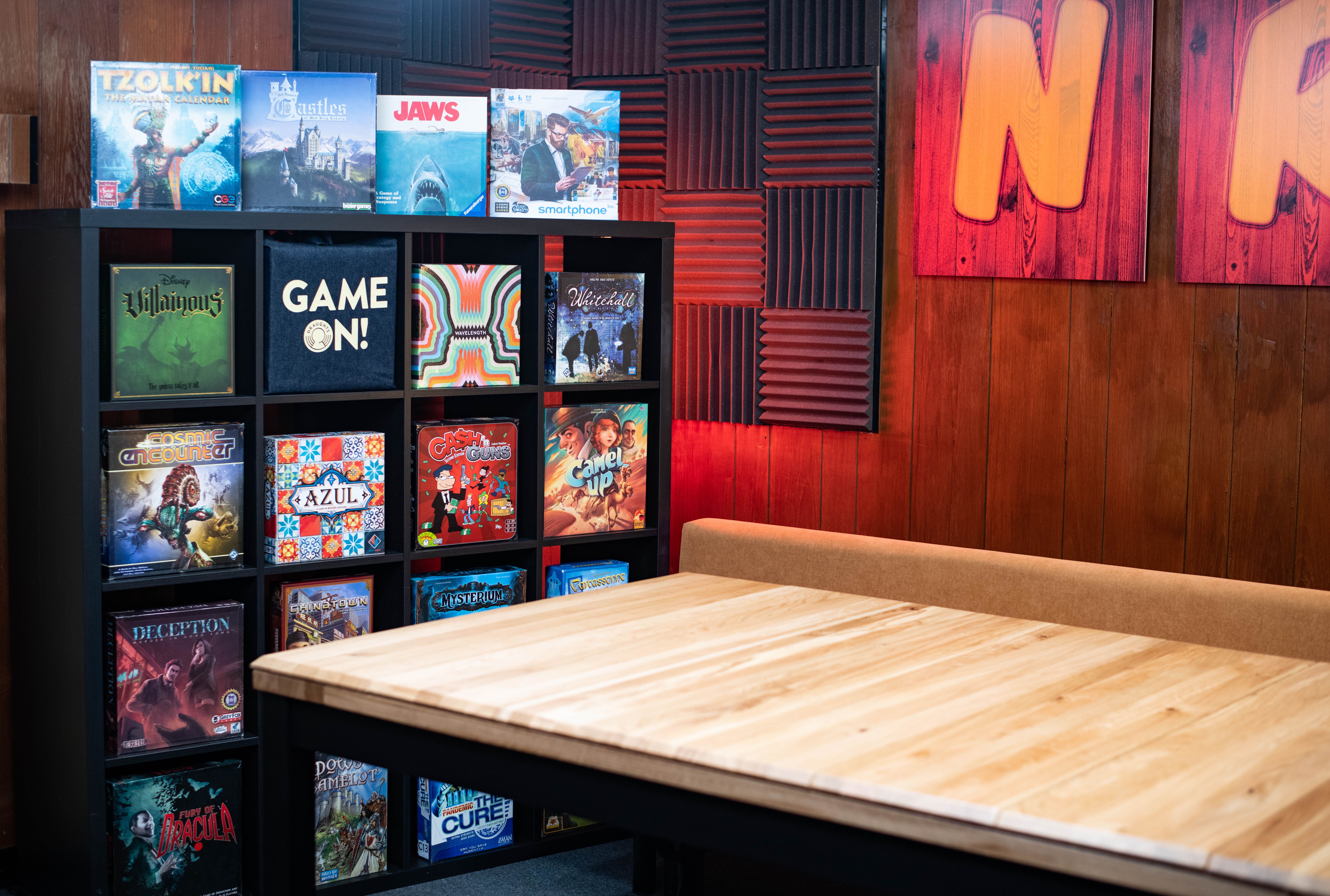 Cozy meeting space with wooden table for team-building and workshops at Draughts Hackney.