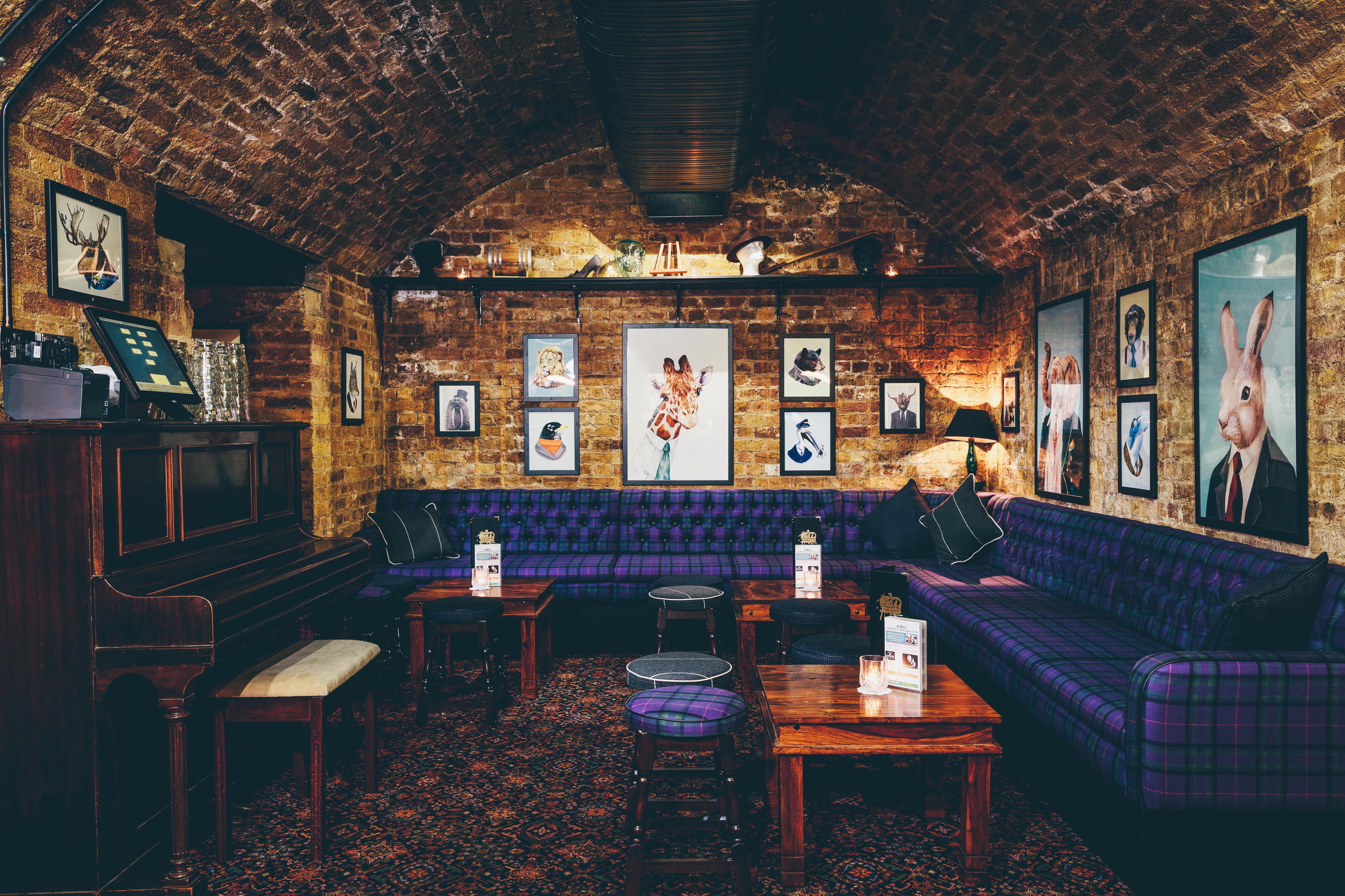 Cozy venue hire at The Cocktail Club Monument with exposed brick and plush seating.