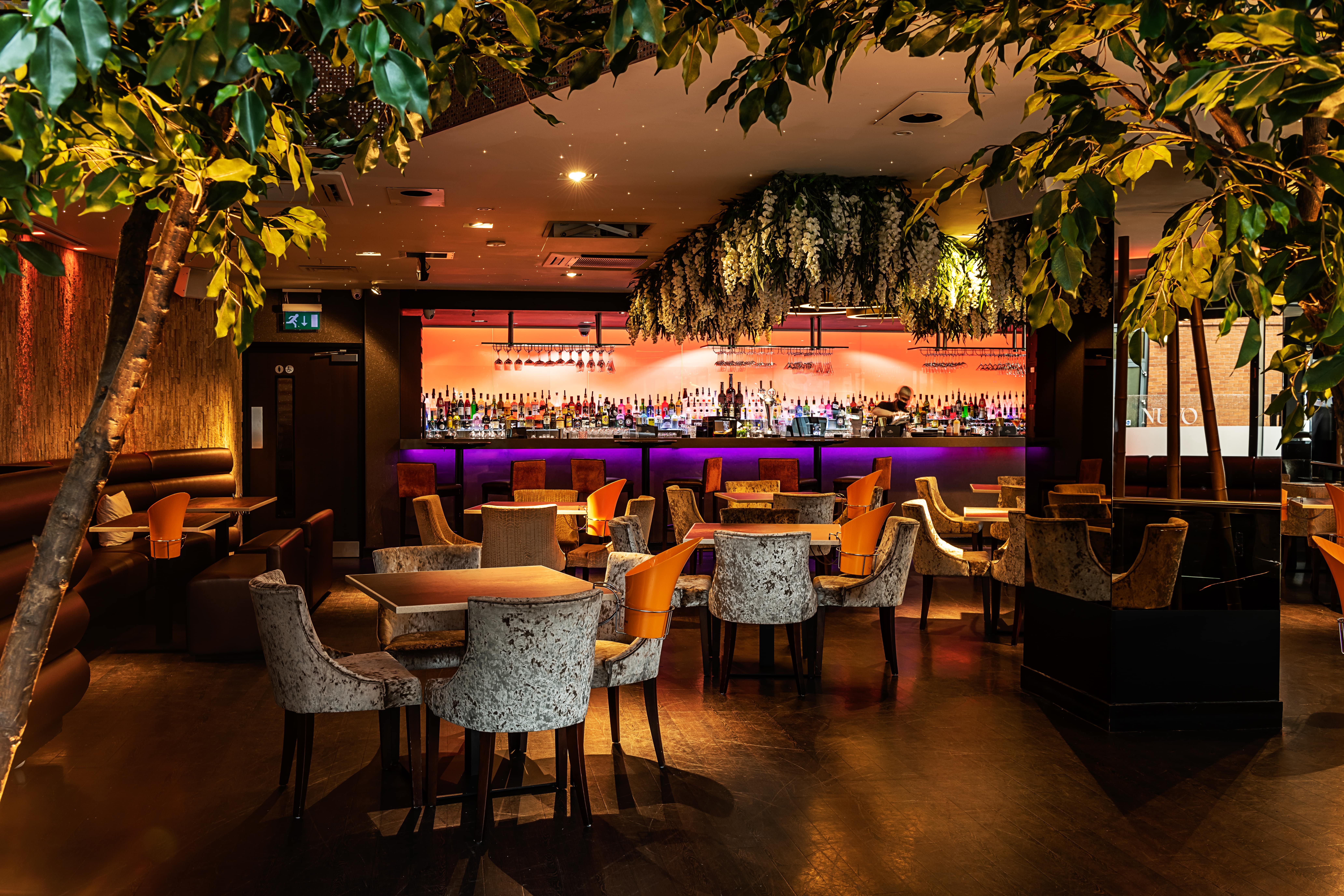 Stylish restaurant bar with vibrant decor for intimate gatherings and networking events.