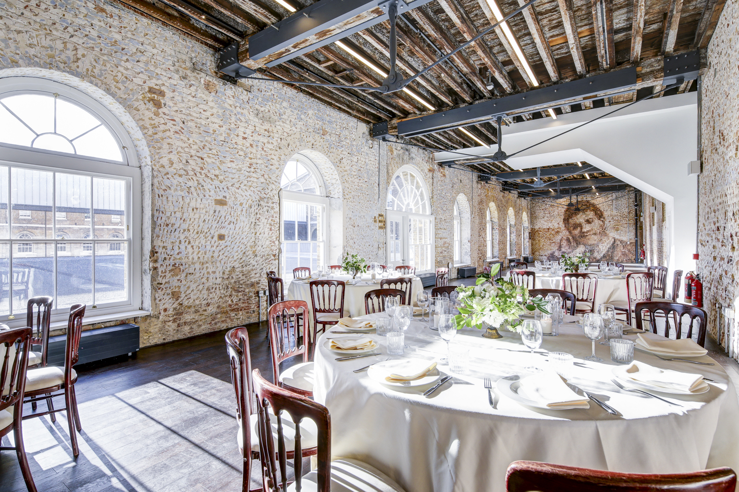 Elegant event space at Knight Gallery with exposed brick and natural light, ideal for gatherings.