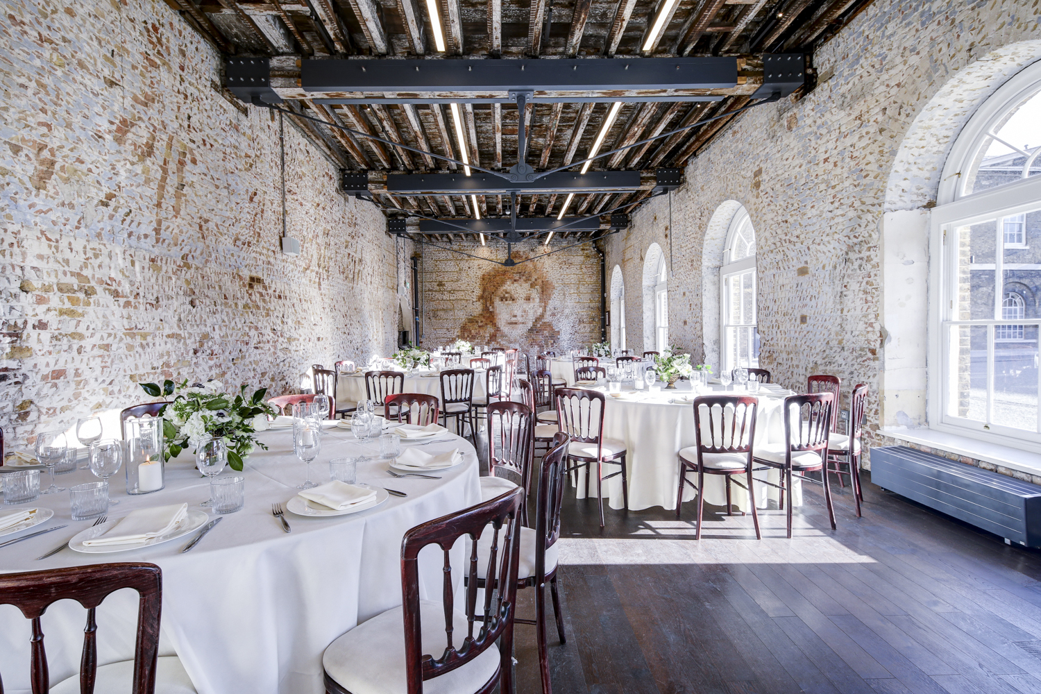 Knight Gallery event space with rustic brick walls, ideal for receptions and gatherings.