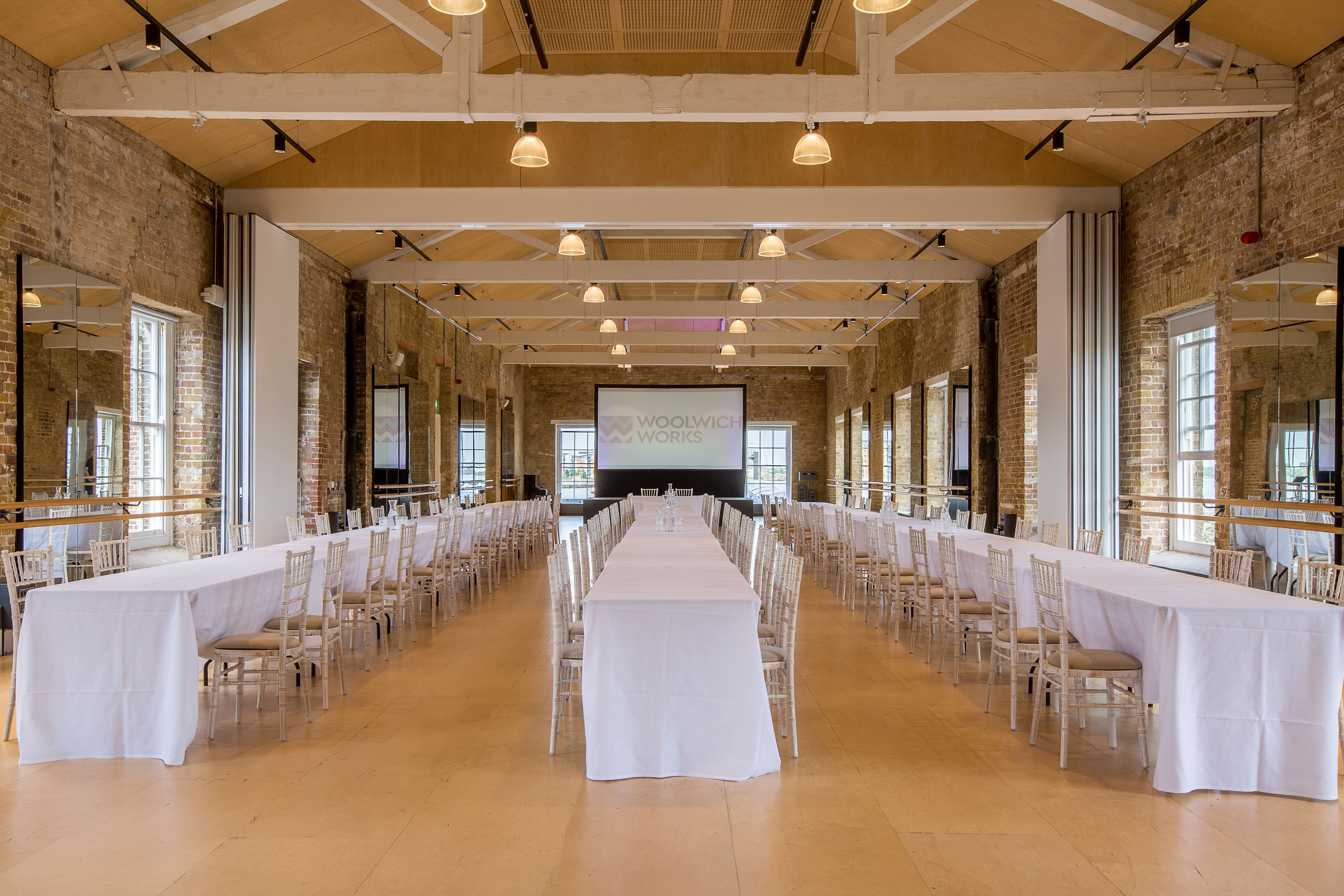 Corporate meeting space with U-shaped tables, ideal for events and workshops.