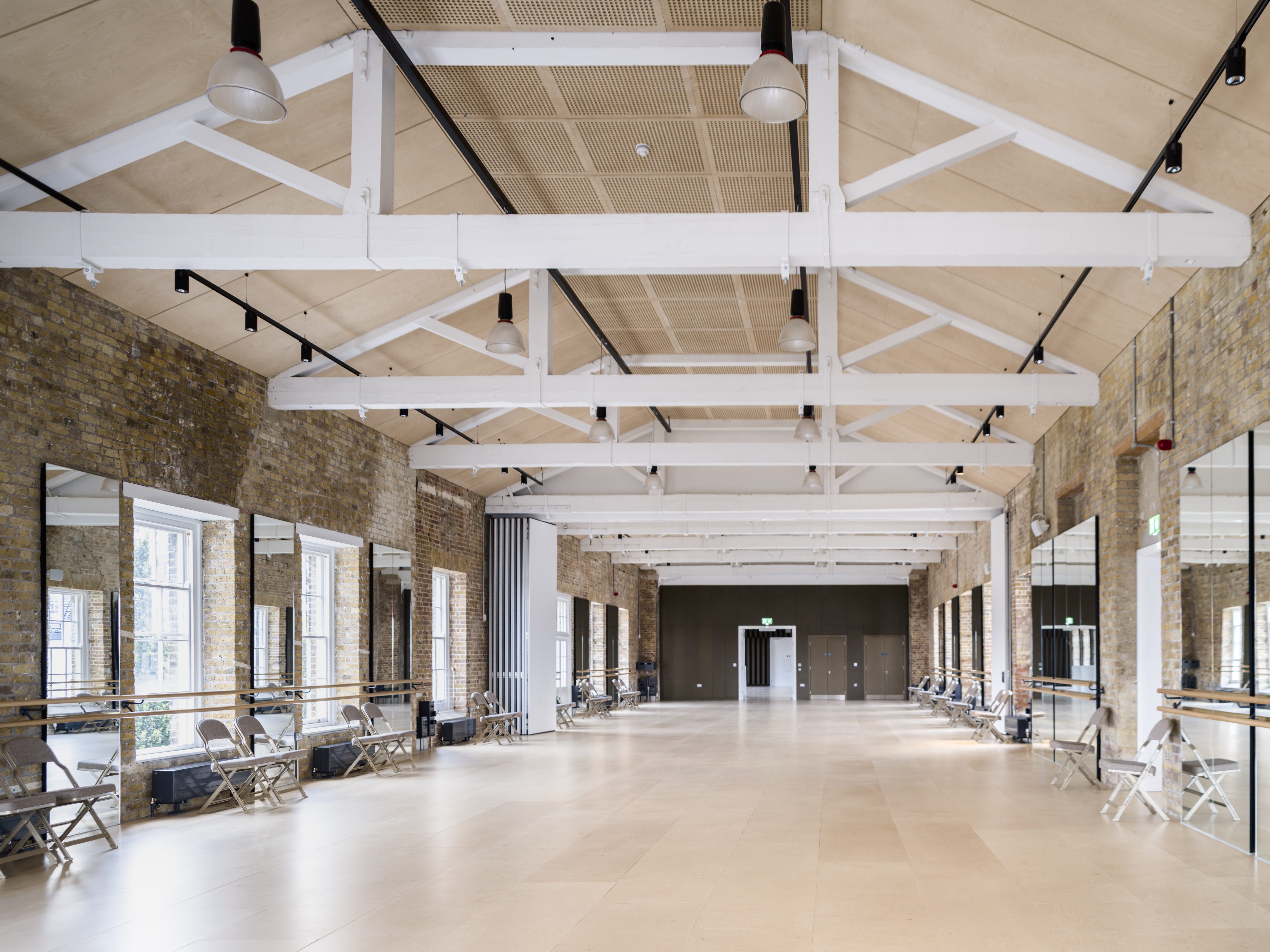 Spacious event space with high ceilings, ideal for workshops and fitness classes.