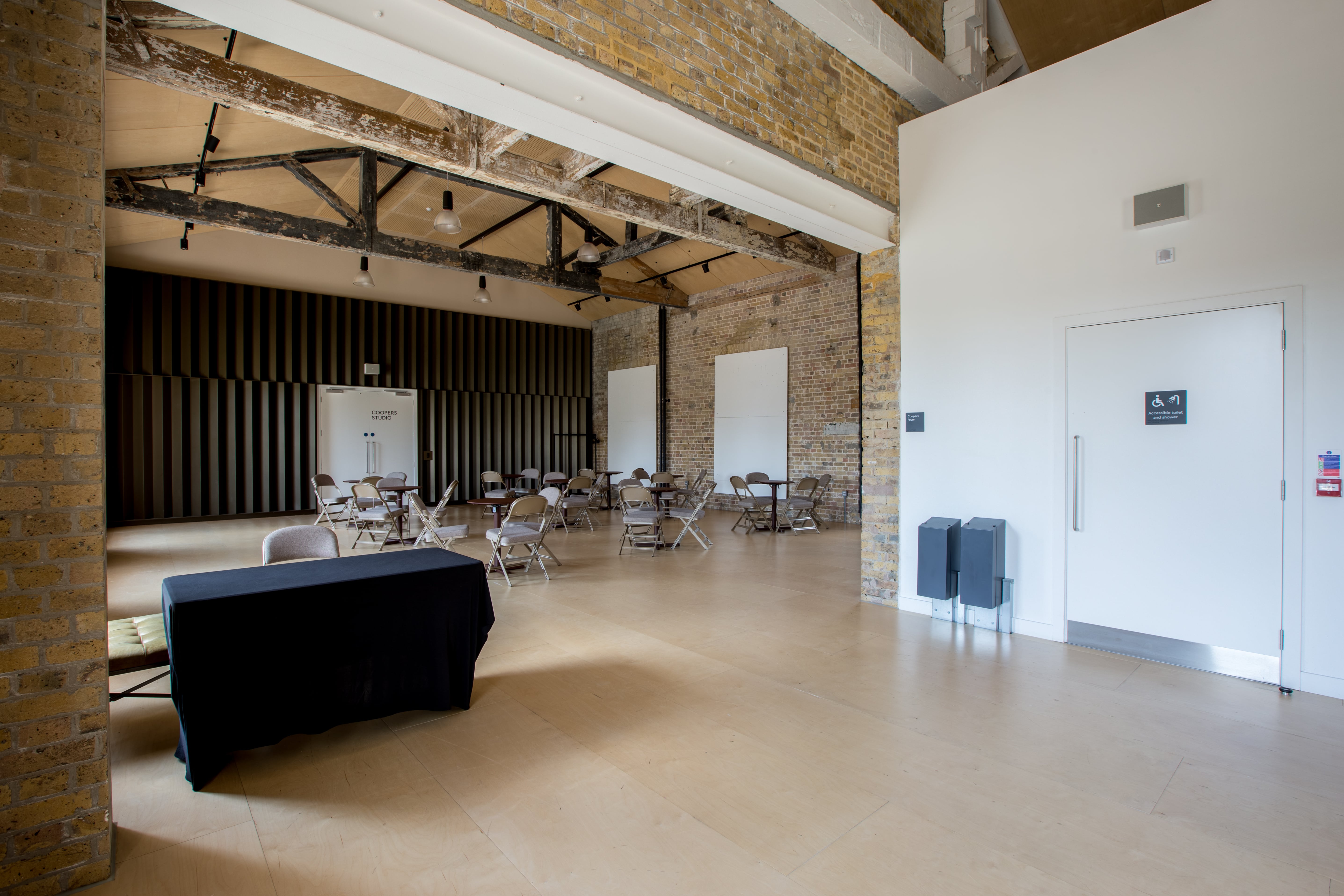 Coopers Studio event space with exposed brick walls, perfect for gatherings and meetings.
