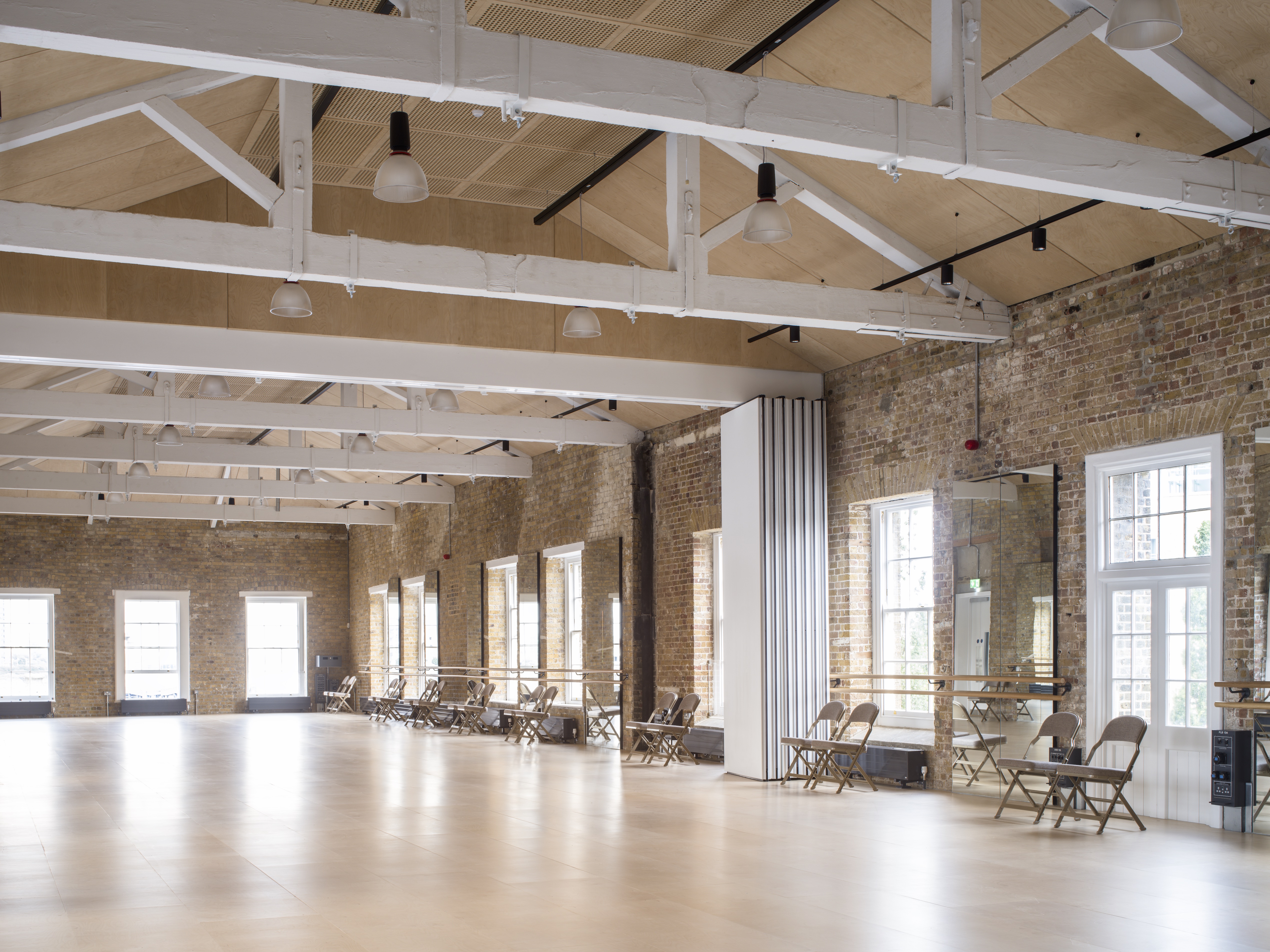 Spacious event venue with high ceilings, ideal for meetings and workshops in Woolwich Works.
