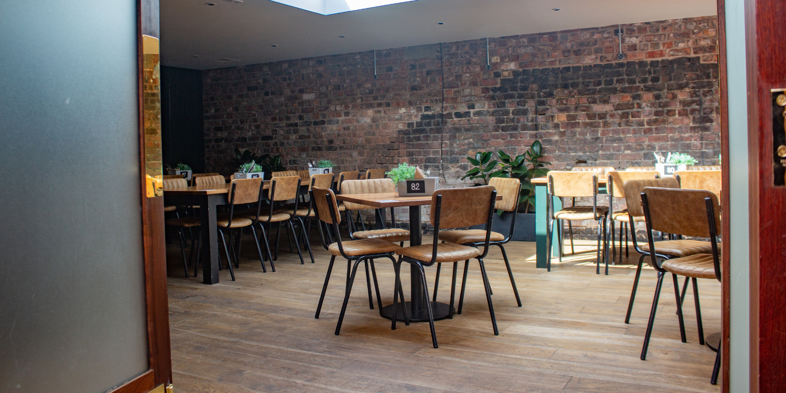 Versatile event space in Duke Street Market with exposed brick, ideal for corporate events.