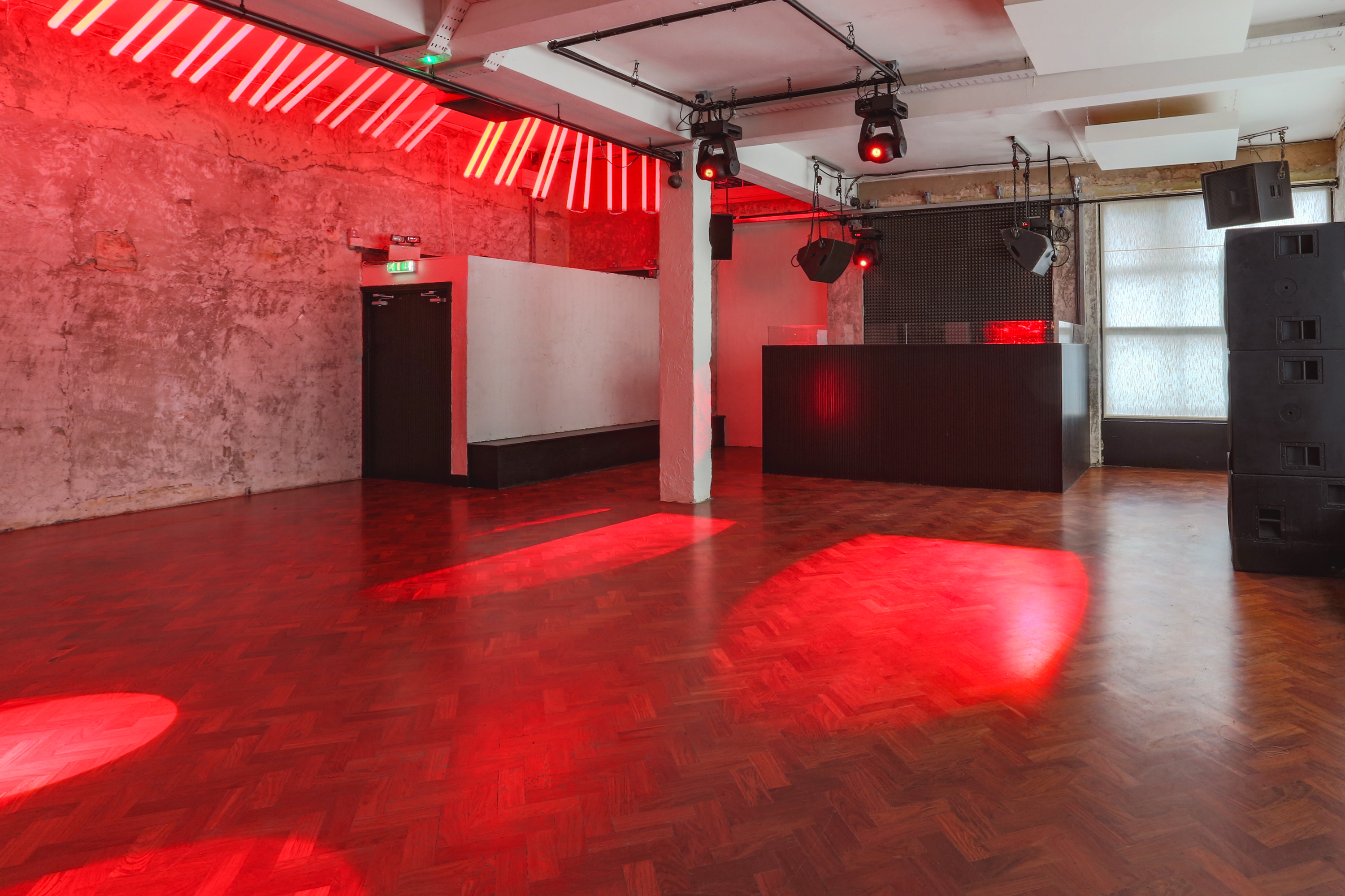 Main Party Area in 93 Feet East: industrial venue with polished wood floor for events.