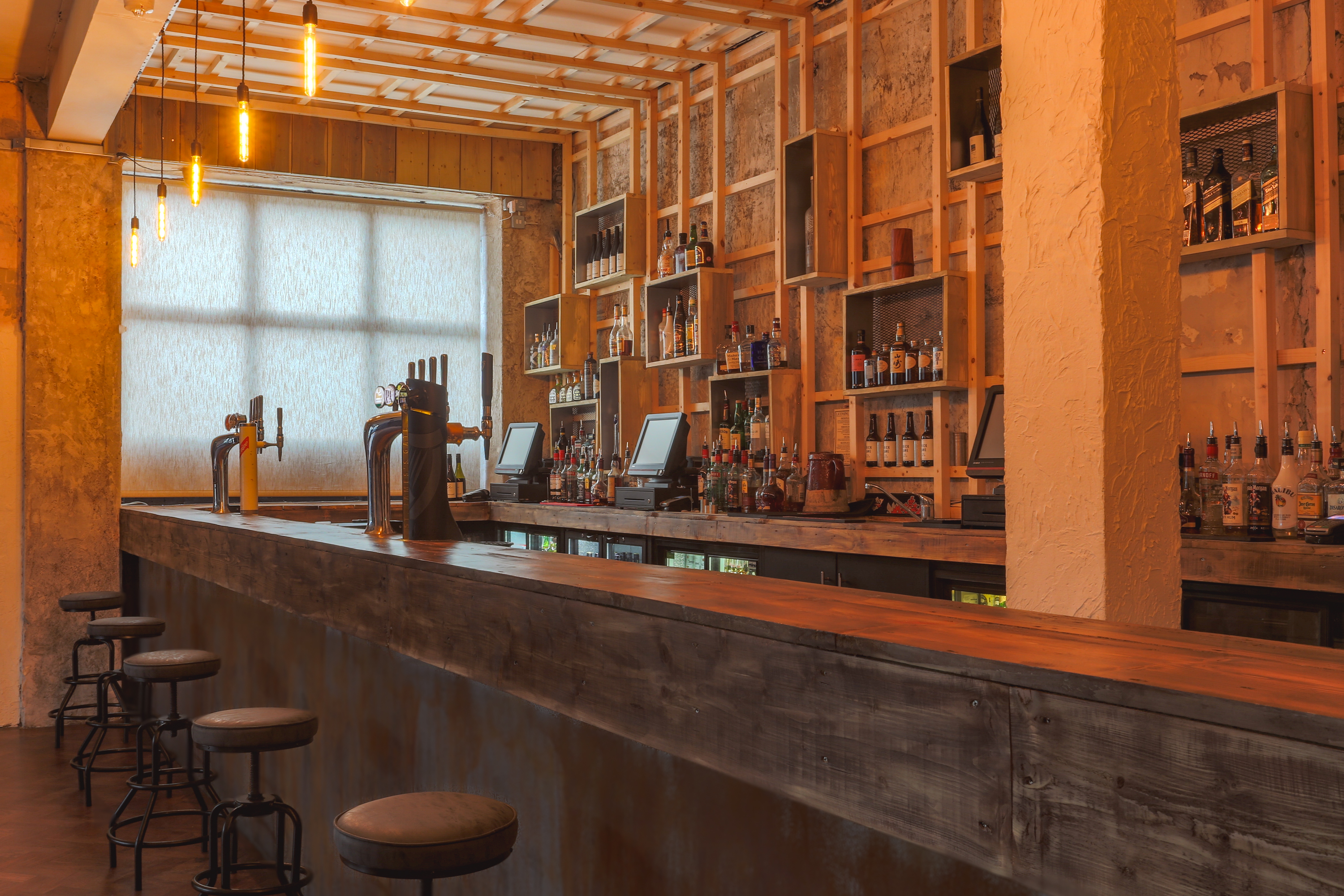Stylish bar setup with warm lighting at 93 Feet East for networking events and gatherings.