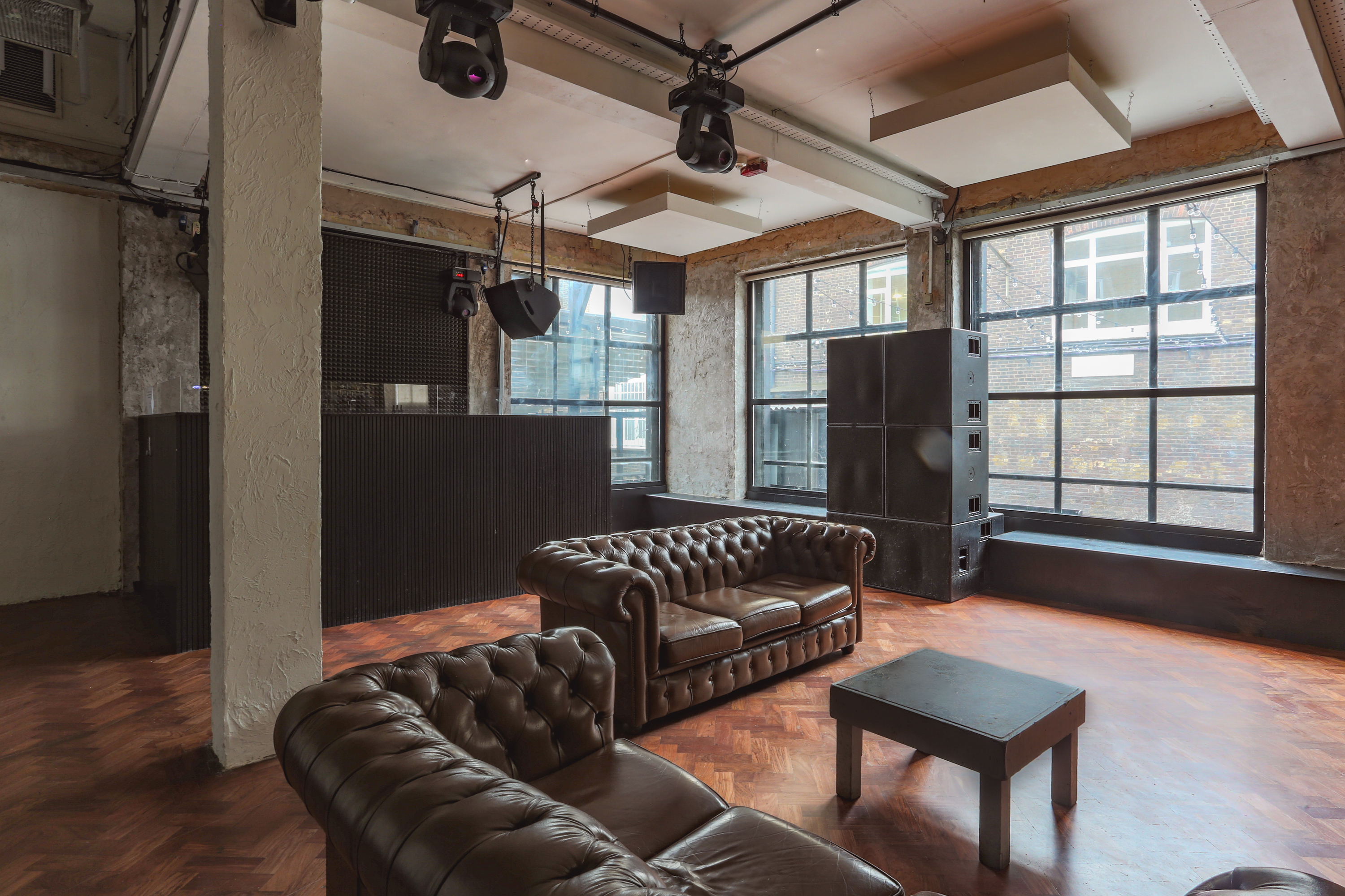 Versatile event space with stylish couches for meetings and gatherings at 93 Feet East.