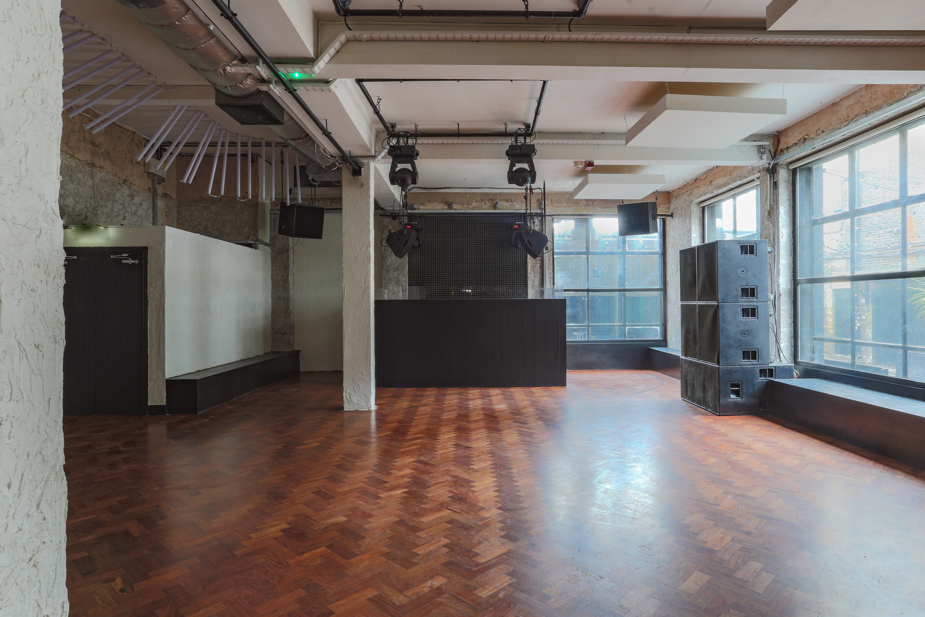 Versatile event space at 93 Feet East with polished wooden floor for meetings and workshops.