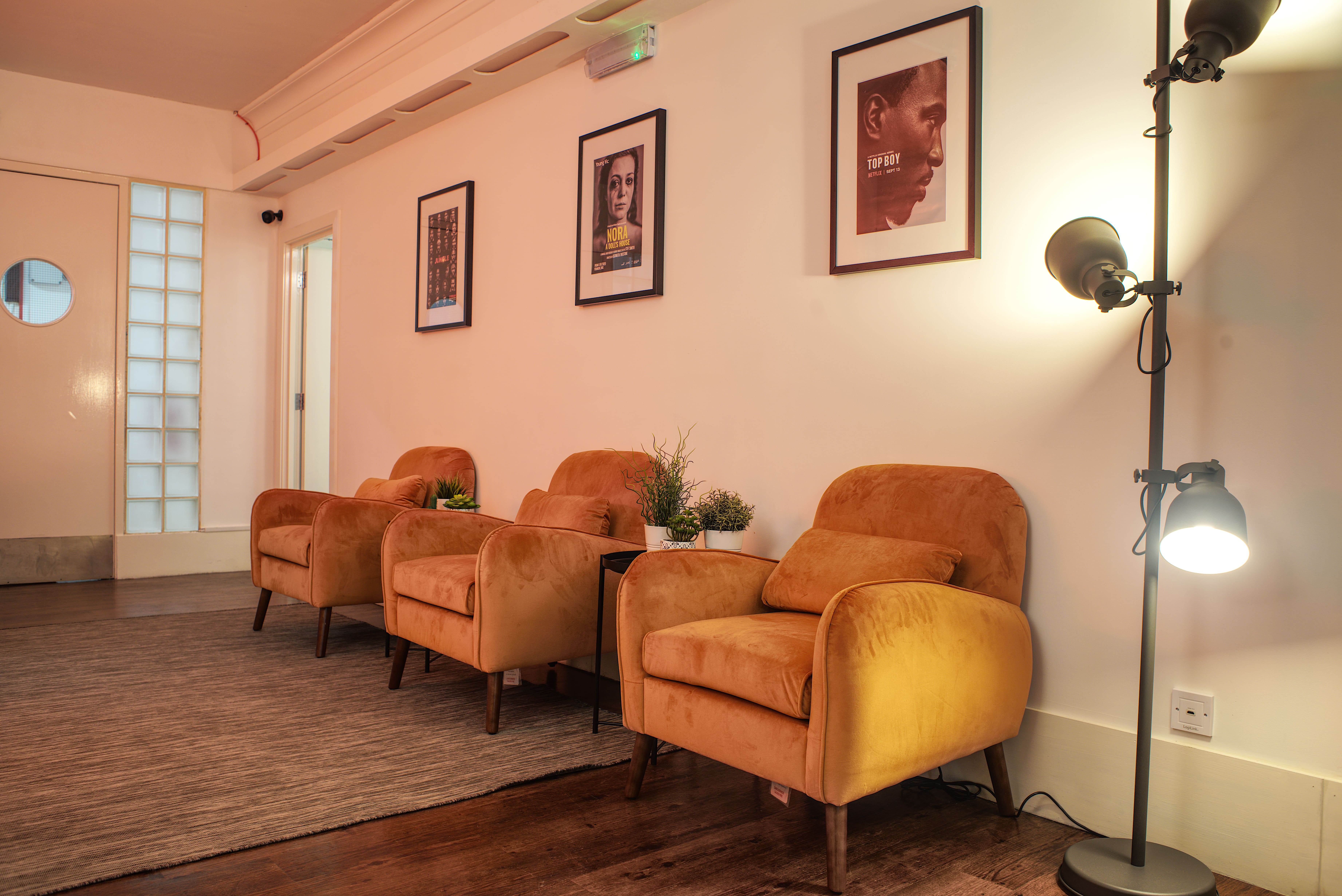 Stylish meeting space with armchairs at Cromer Studios, ideal for networking and collaboration.