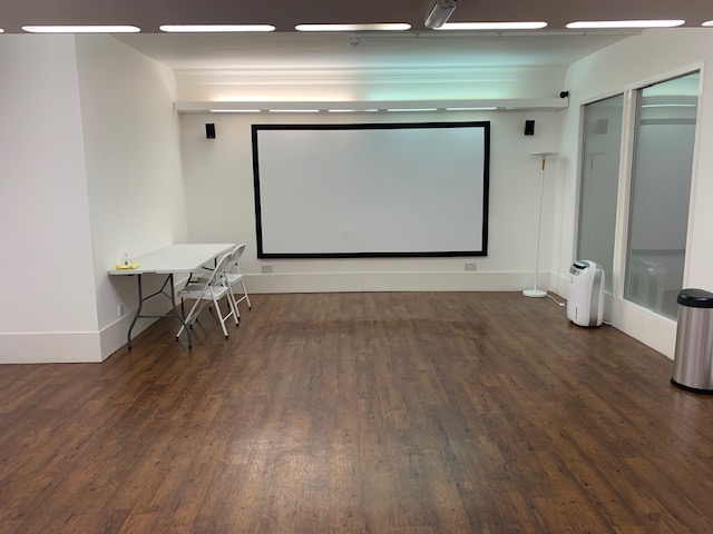 Versatile meeting space at Cromer Studios with large projection screen for workshops.
