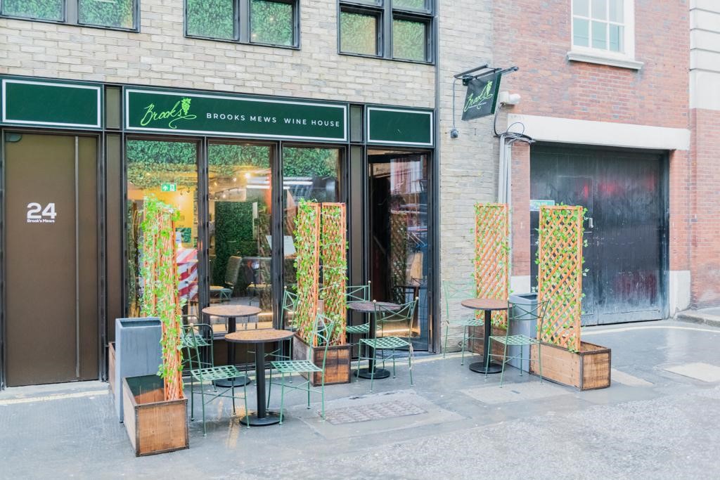 Charming outdoor seating at Brooks Mews Wine House for casual meetings and networking.