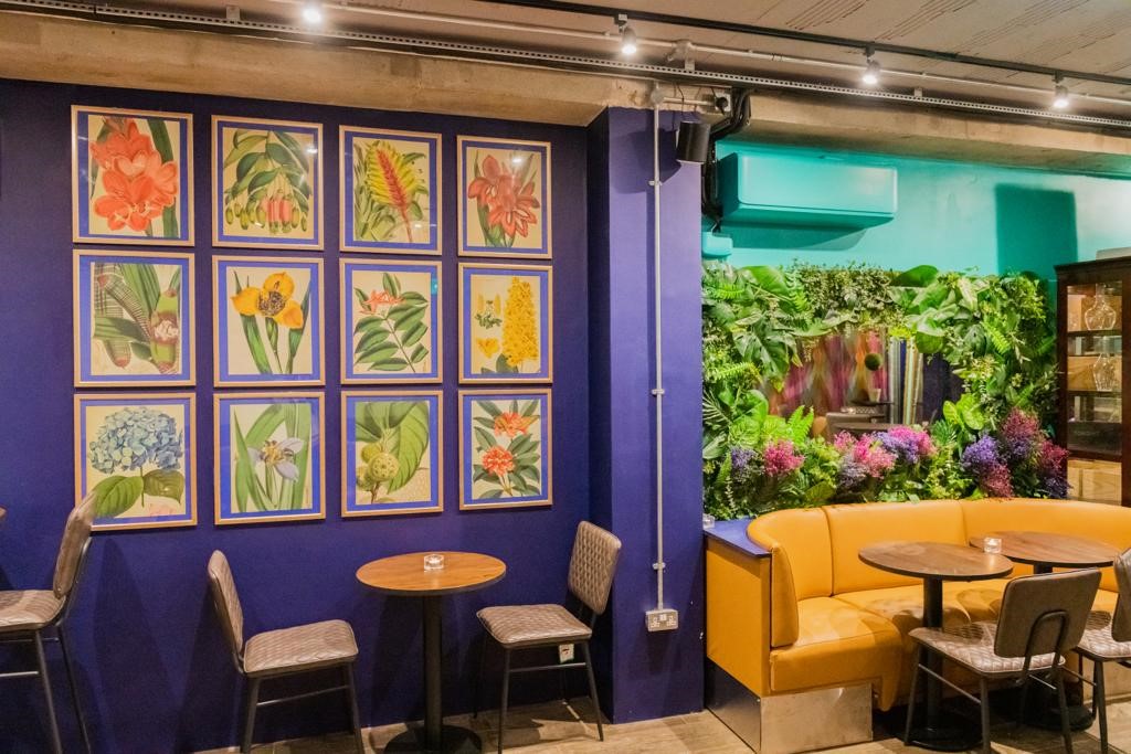 Vibrant event space with floral art, ideal for gatherings and networking at Brooks Mews Wine House.