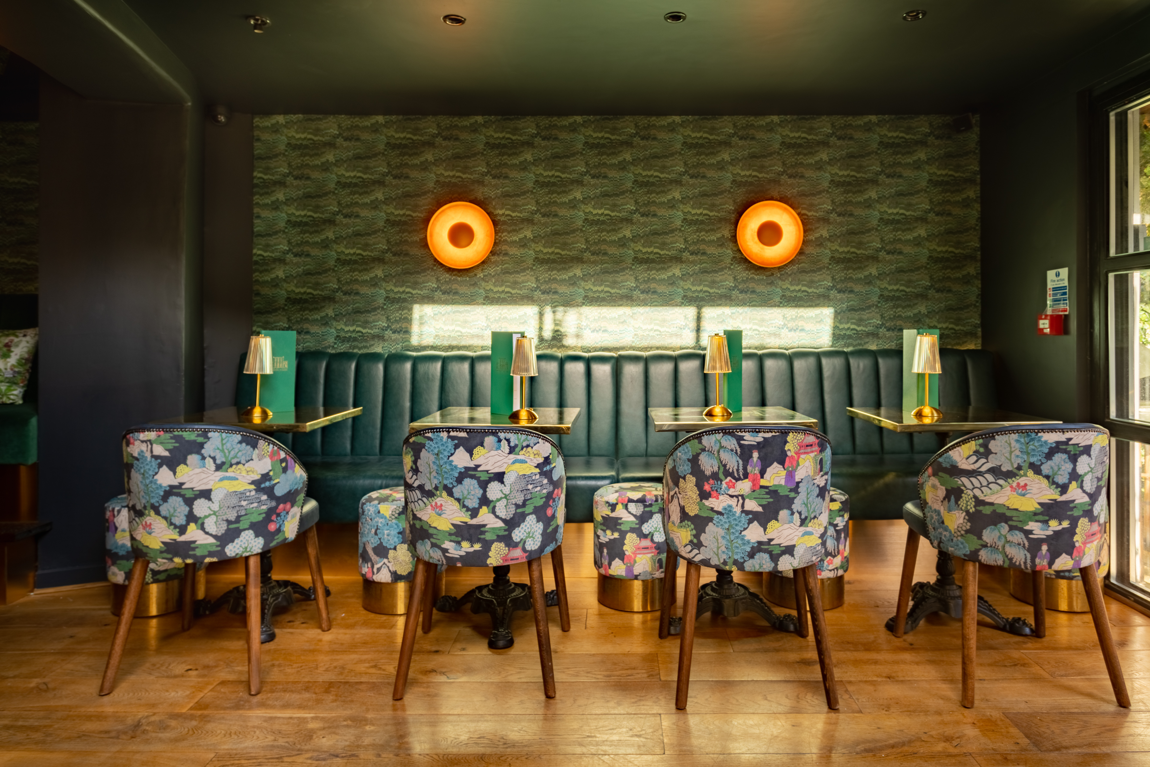 Stylish meeting space at Arthurs Bar with floral chairs, ideal for networking events.