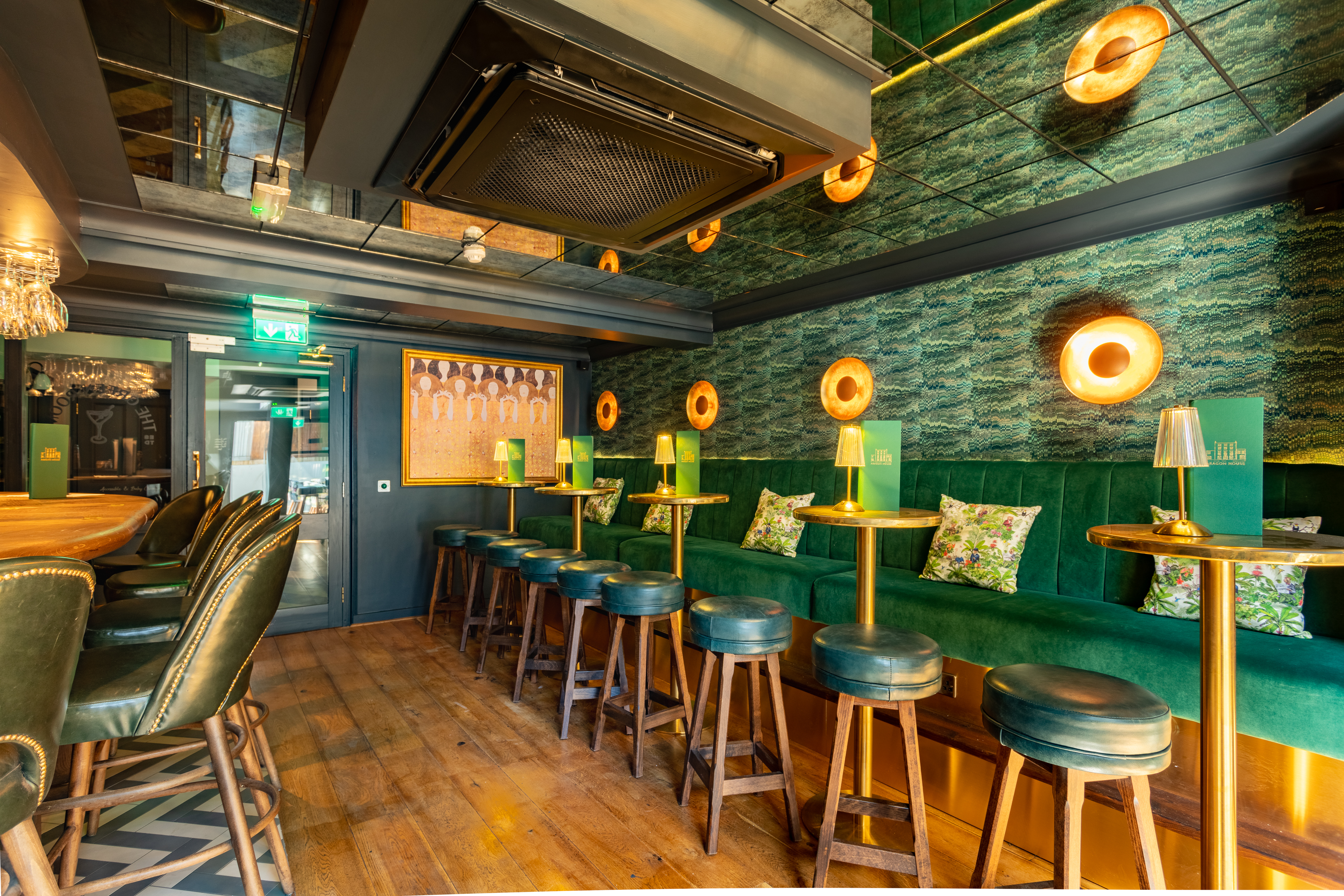 Stylish Arthurs Bar with plush green seating, perfect for cocktail receptions and networking.