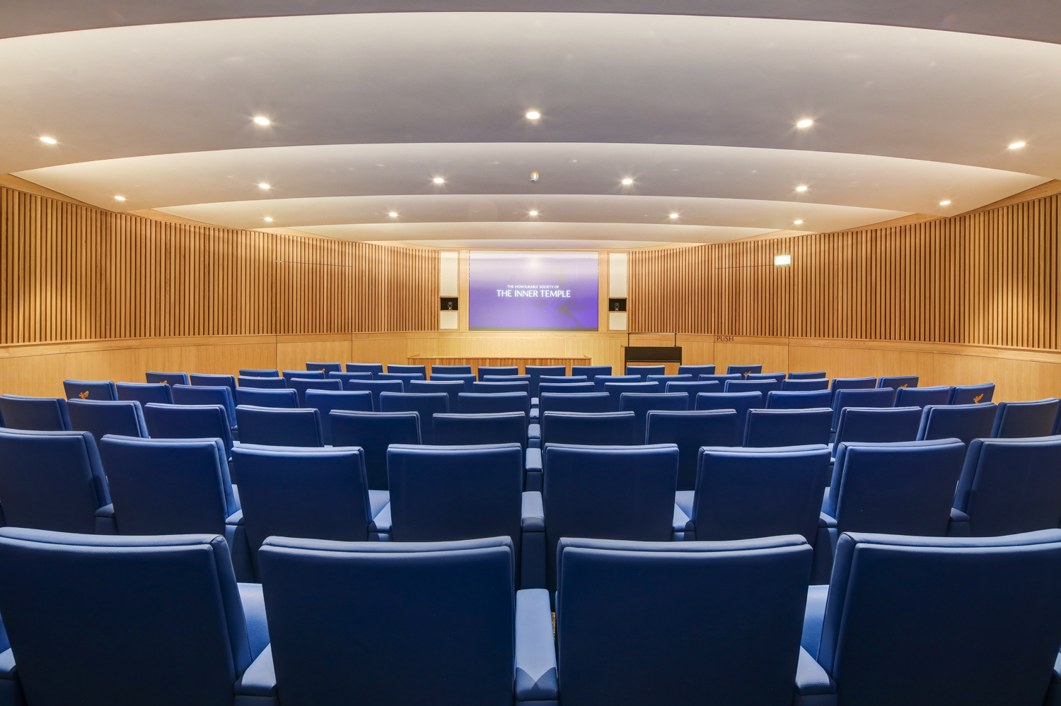 Modern lecture theatre with tiered seating for conferences and presentations.