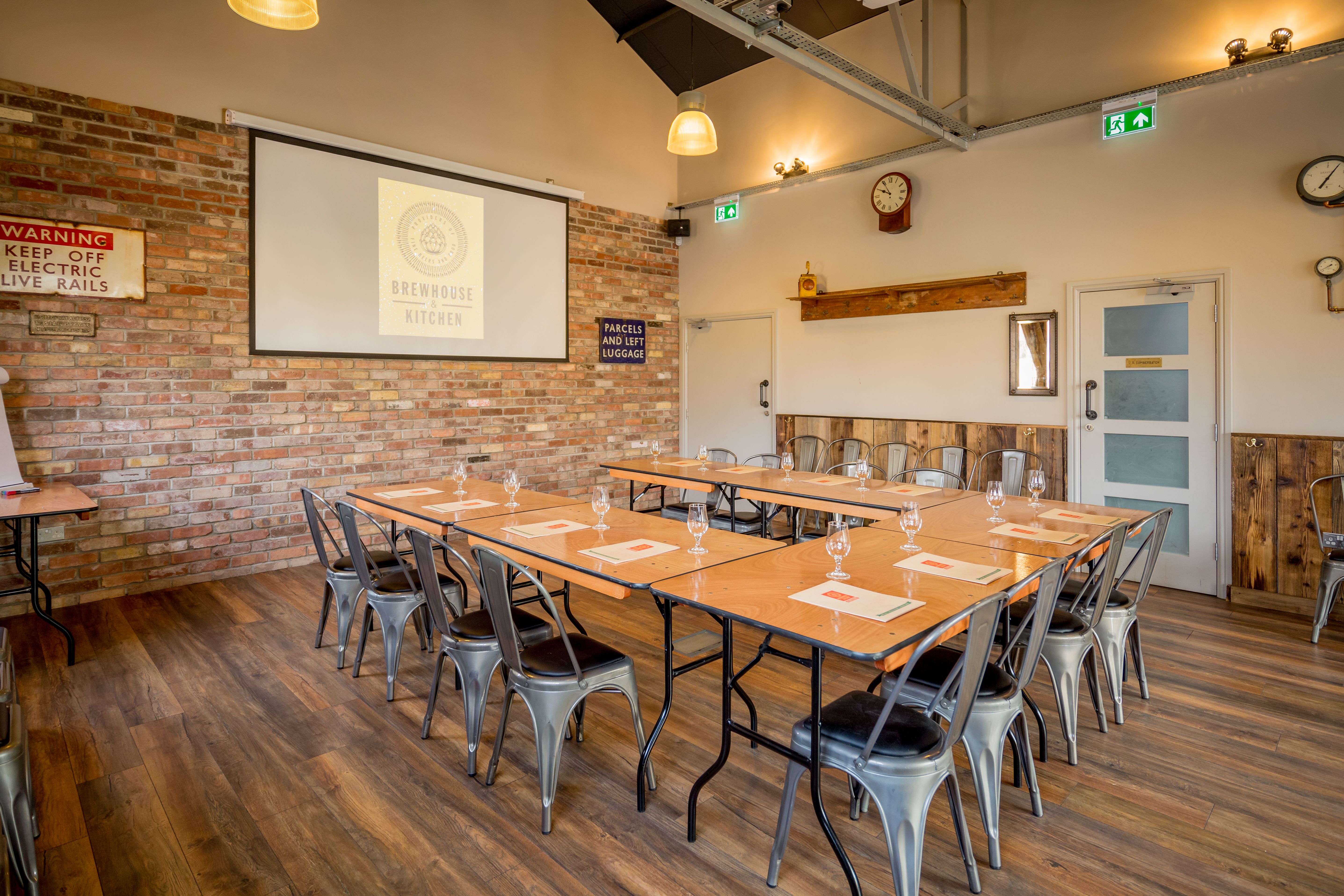 The Tap Room meeting space with U-shaped tables, ideal for workshops and team meetings.