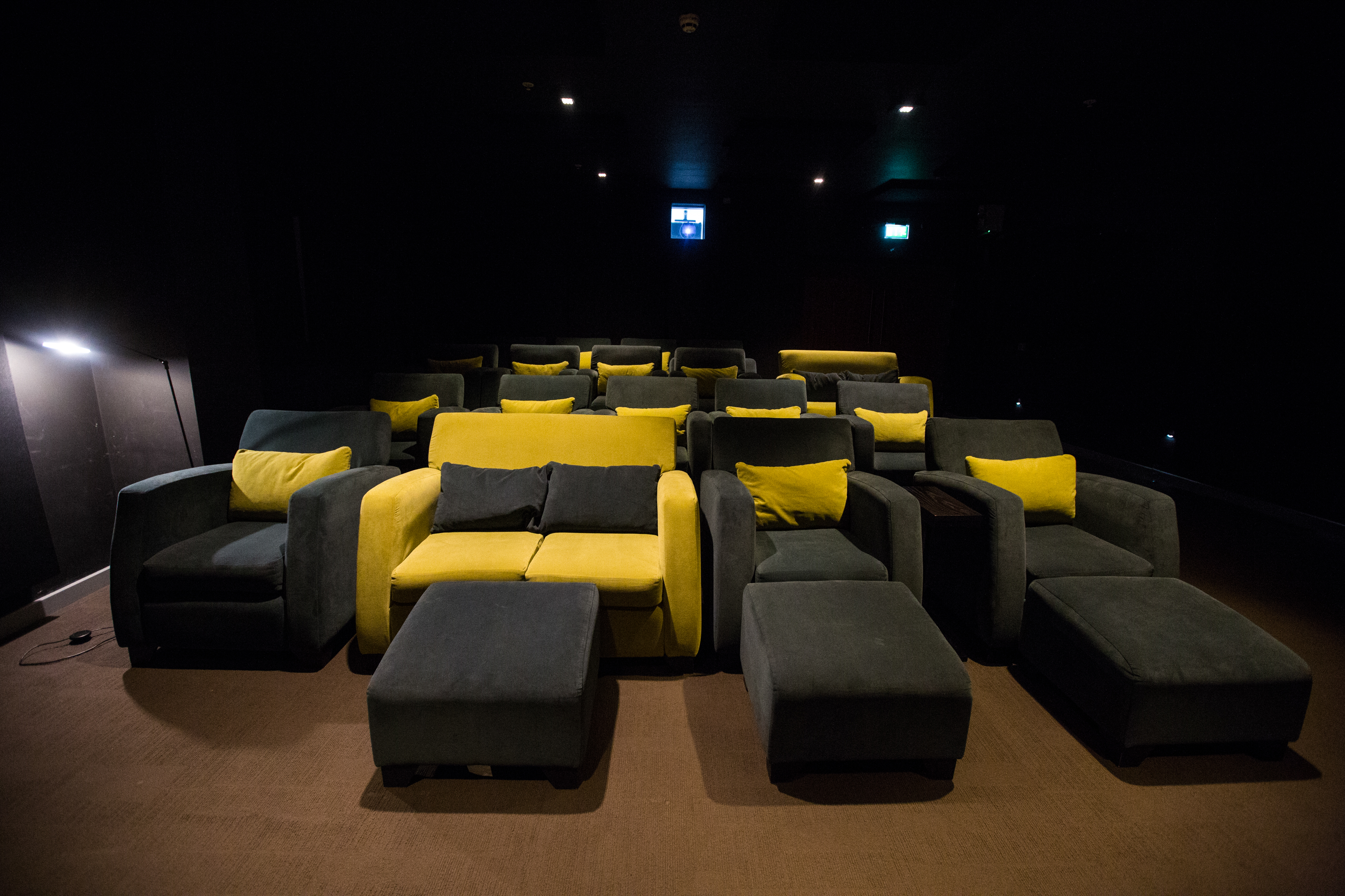 Modern cinema room with cozy seating, ideal for intimate meetings and presentations.