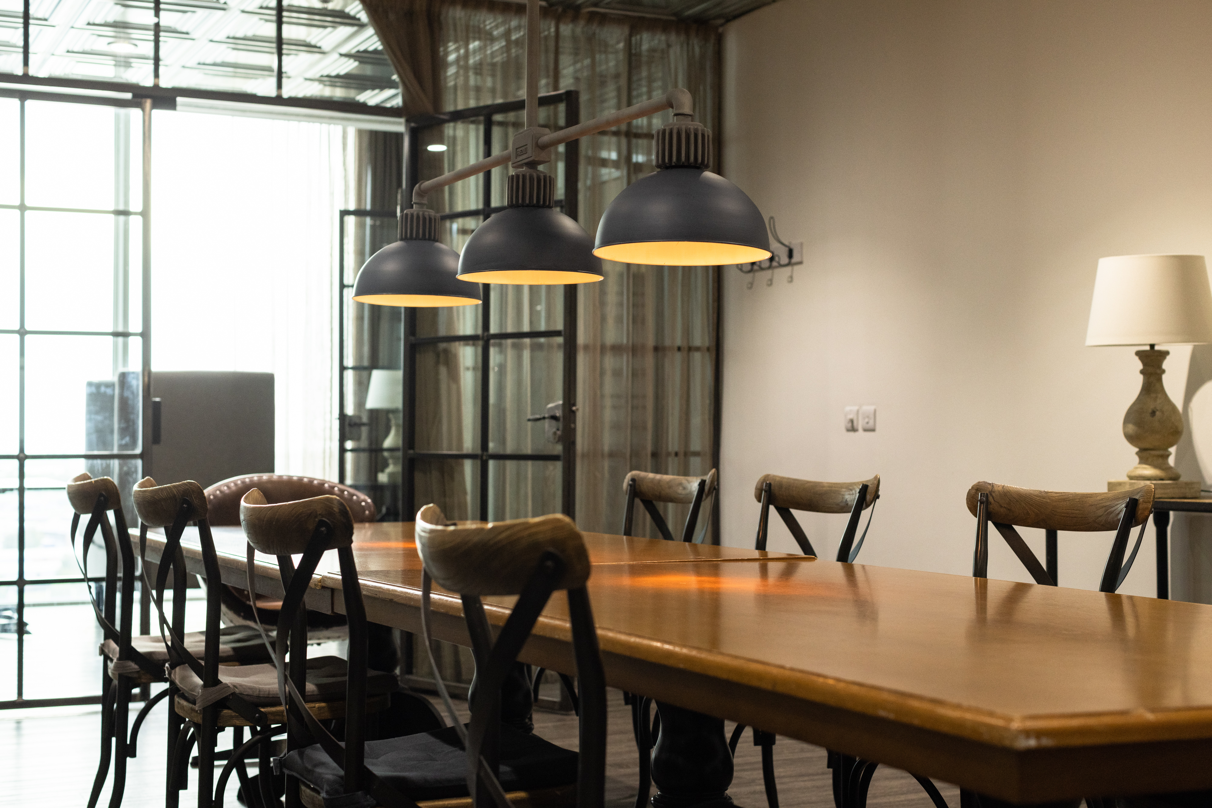 Modern conference room with wooden table, ideal for meetings and brainstorming sessions.