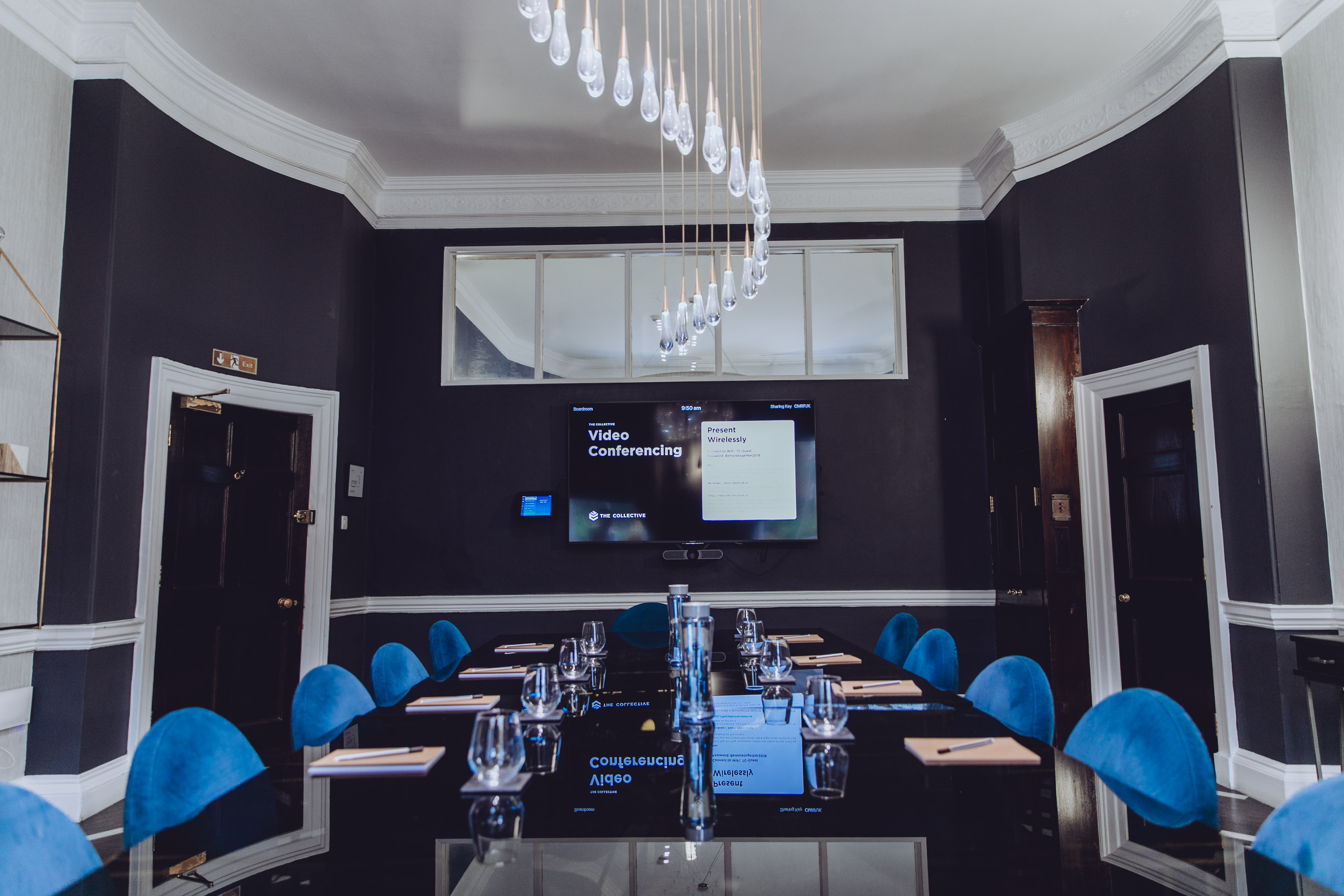 Modern conference room with sleek black walls for high-level meetings and presentations.