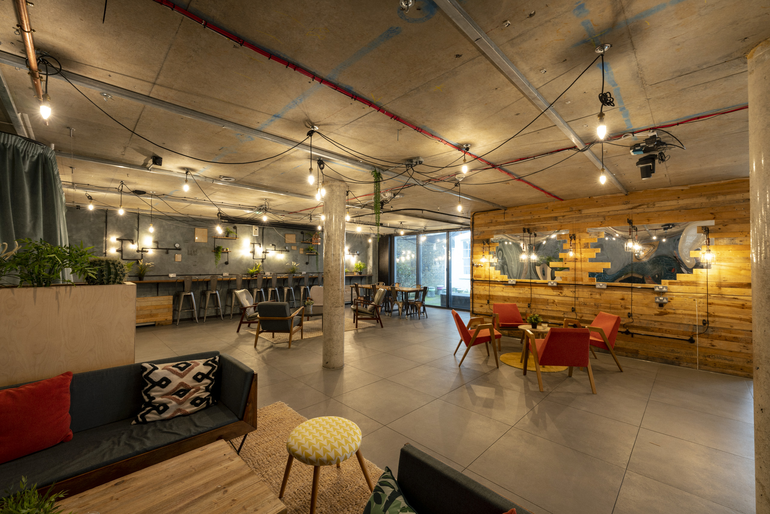 Modern event space with stylish seating and warm lighting, perfect for networking events.