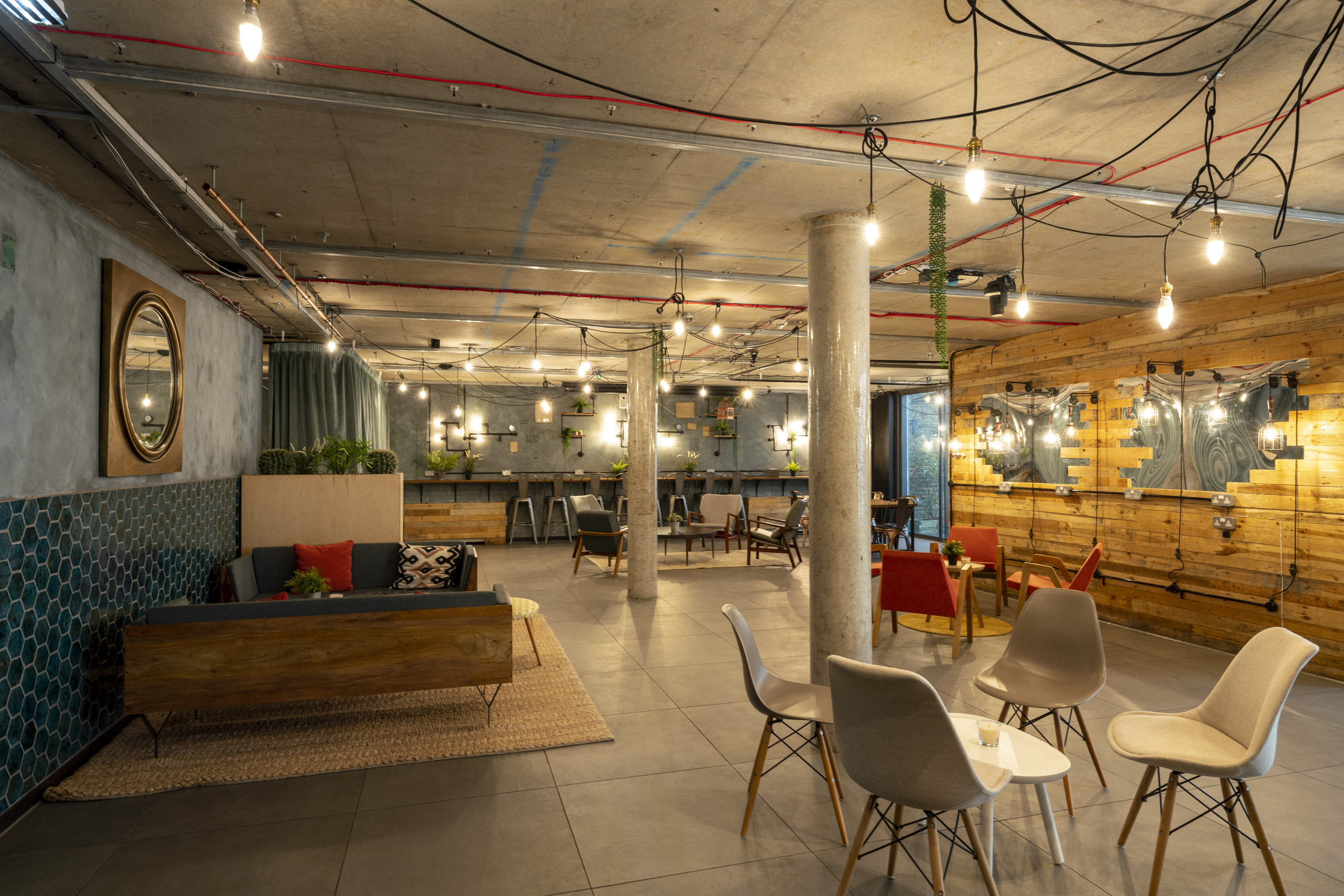 Modern industrial event space with warm accents, perfect for networking and meetings.