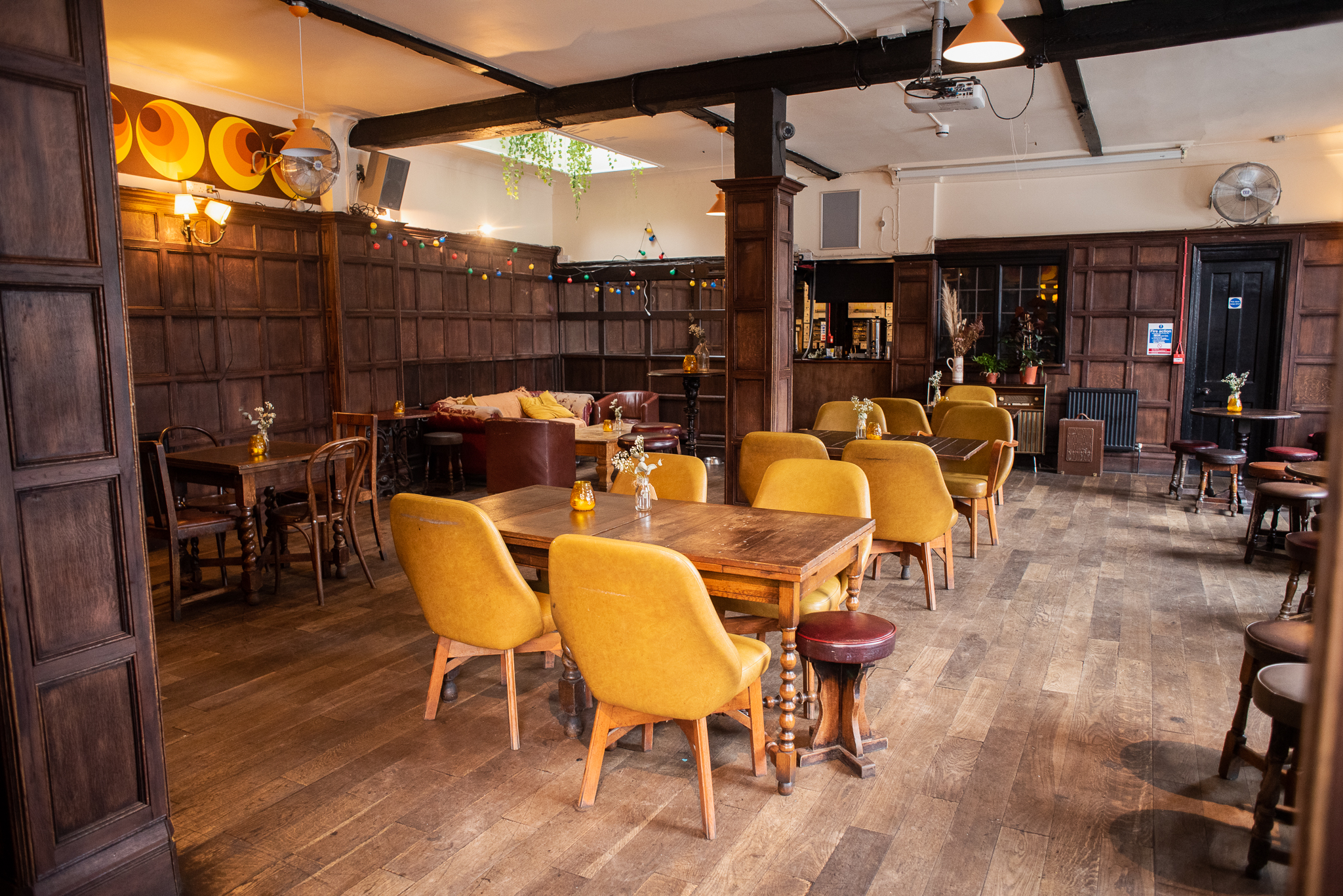 Cozy Beehive Function Room with wooden paneling, ideal for meetings and gatherings.