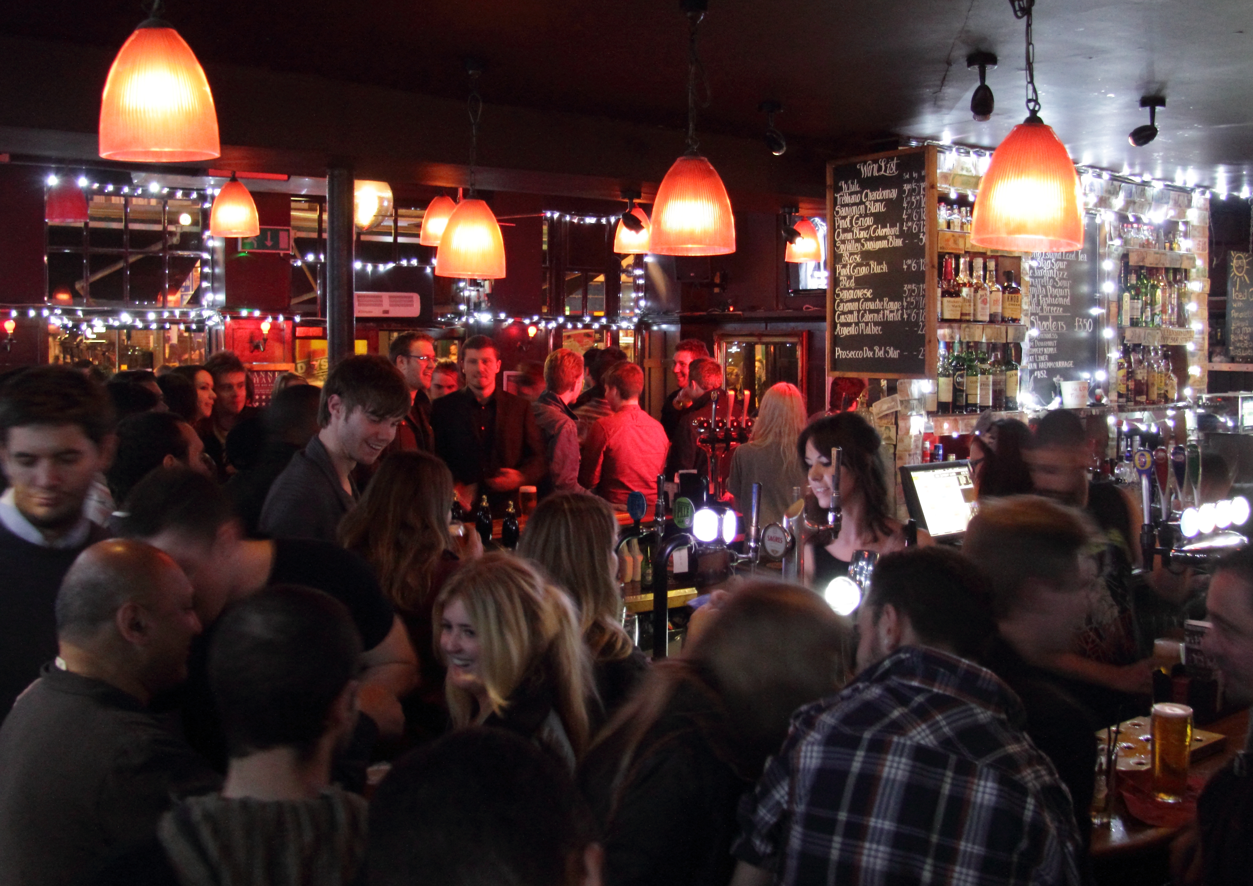 Vibrant Camden Head bar scene, warm lighting for networking events and gatherings.