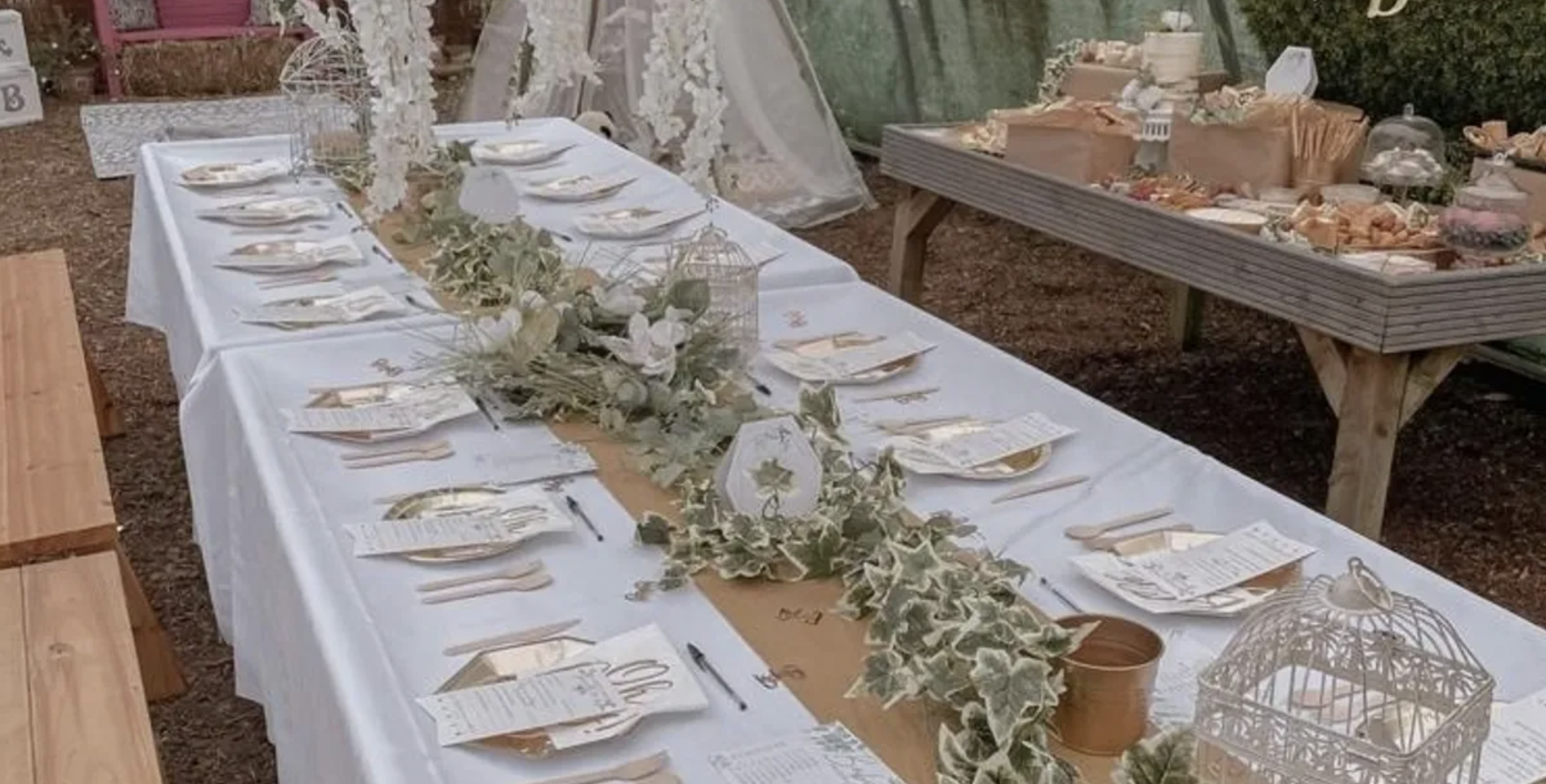 Elegant event table with white linens and floral decor at Secret Garden Event Space.