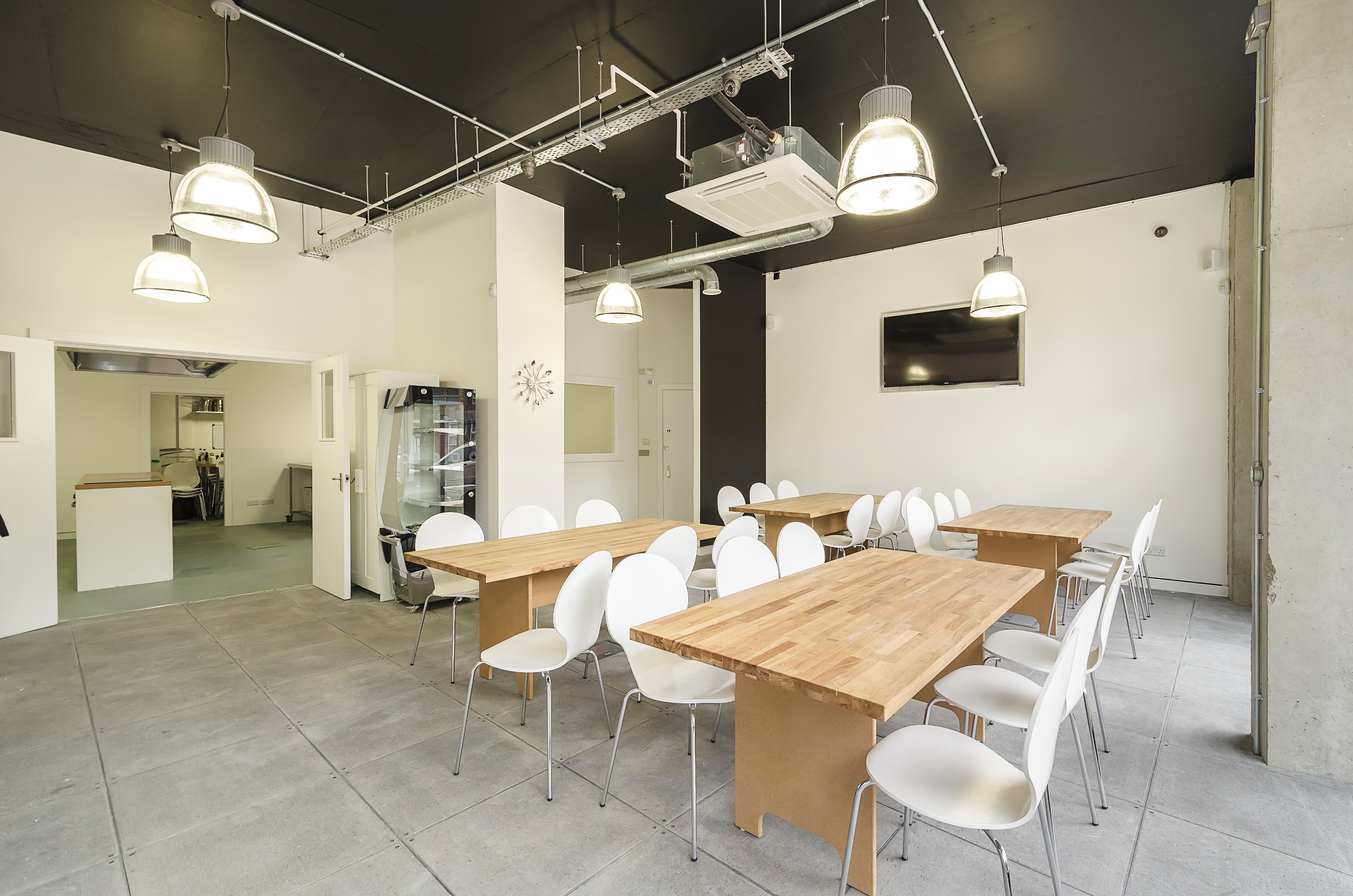 In-person group cookery experience in a modern, light-filled meeting space.