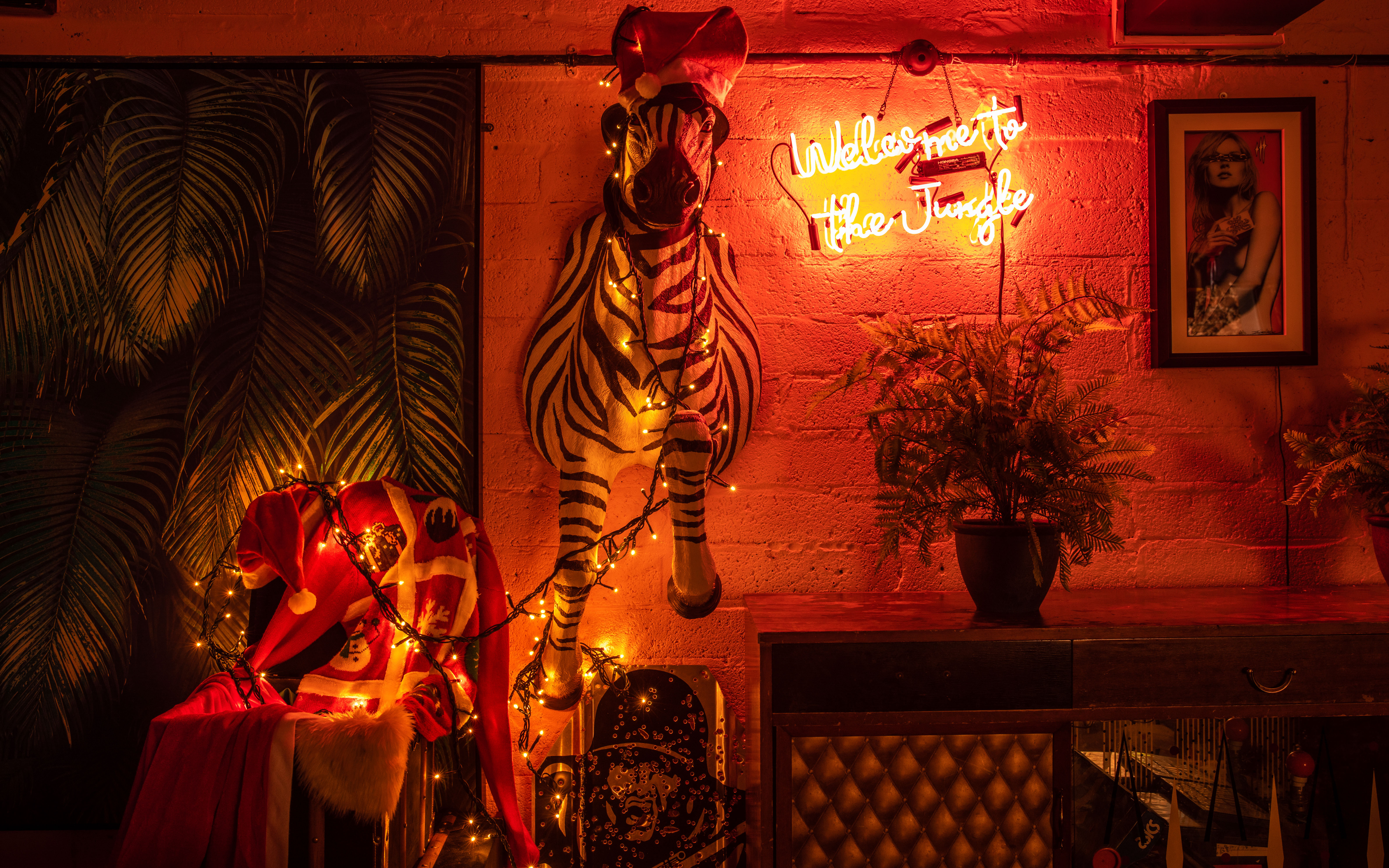 Vibrant Christmas party venue with zebra decor and warm lighting for themed events.