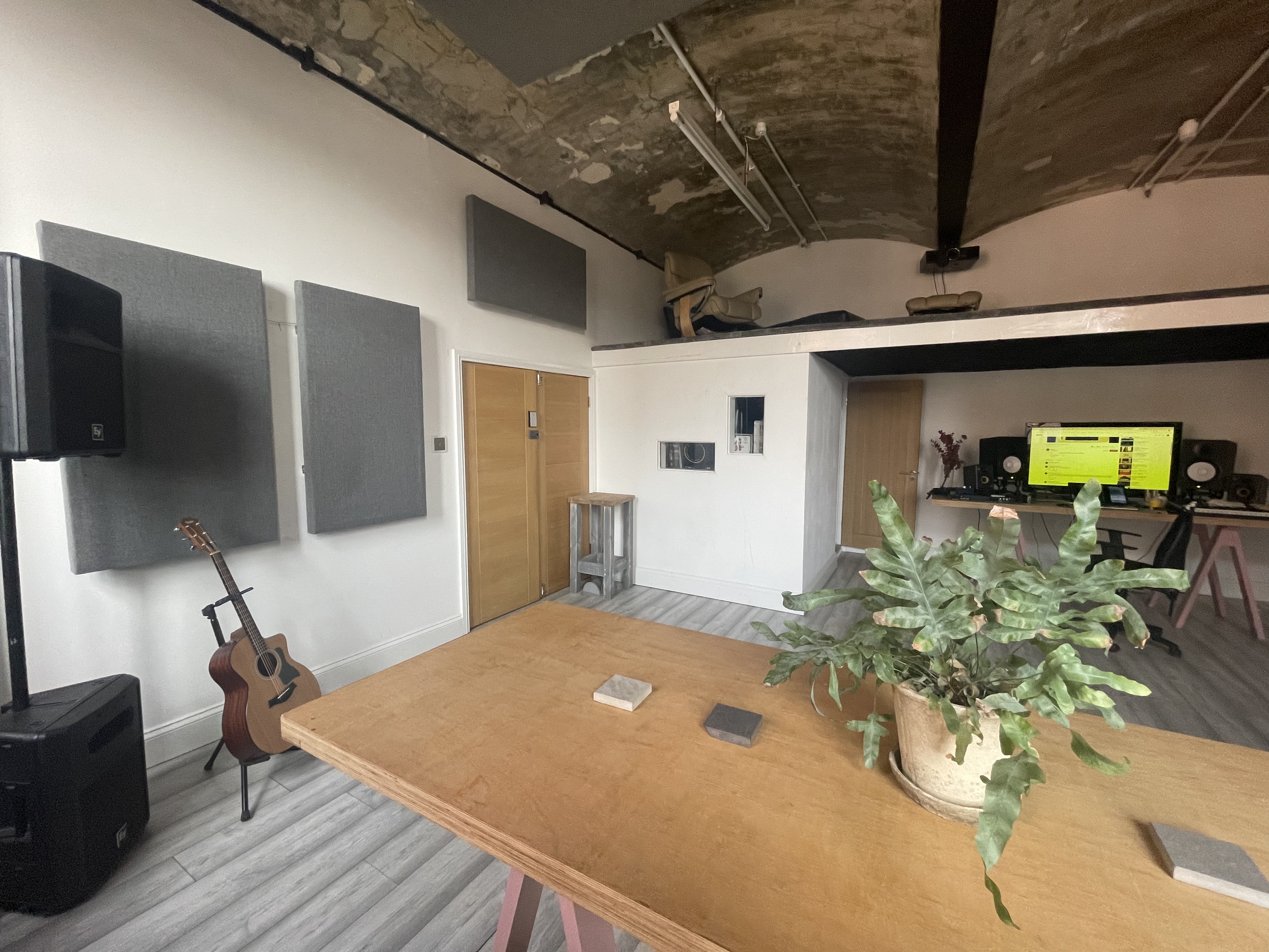 Versatile meeting space with acoustic panels for team-building events and workshops.