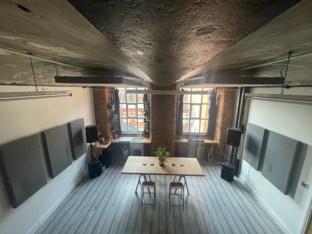 Versatile meeting space with large windows, ideal for collaborative events and presentations.