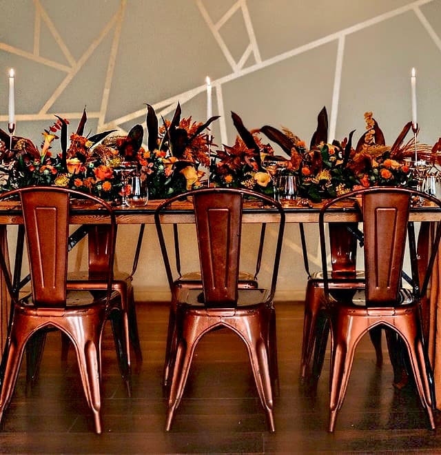 Industrial-chic copper seating with autumnal florals at The Venue on Middle St for event styling.