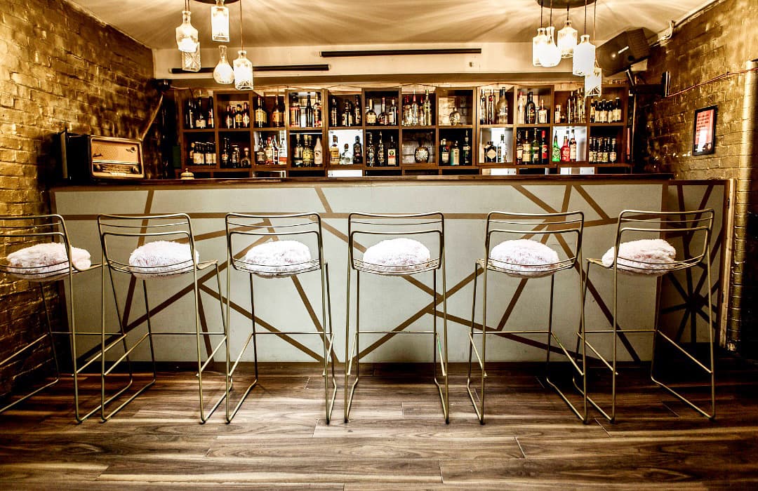 Exposed brick VIP networking lounge at The Venue on Middle St for corporate receptions.