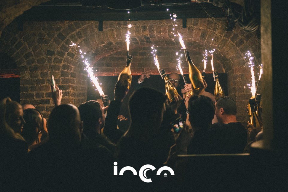 Vibrant corporate celebration at Luna Lounge, featuring champagne and sparklers.