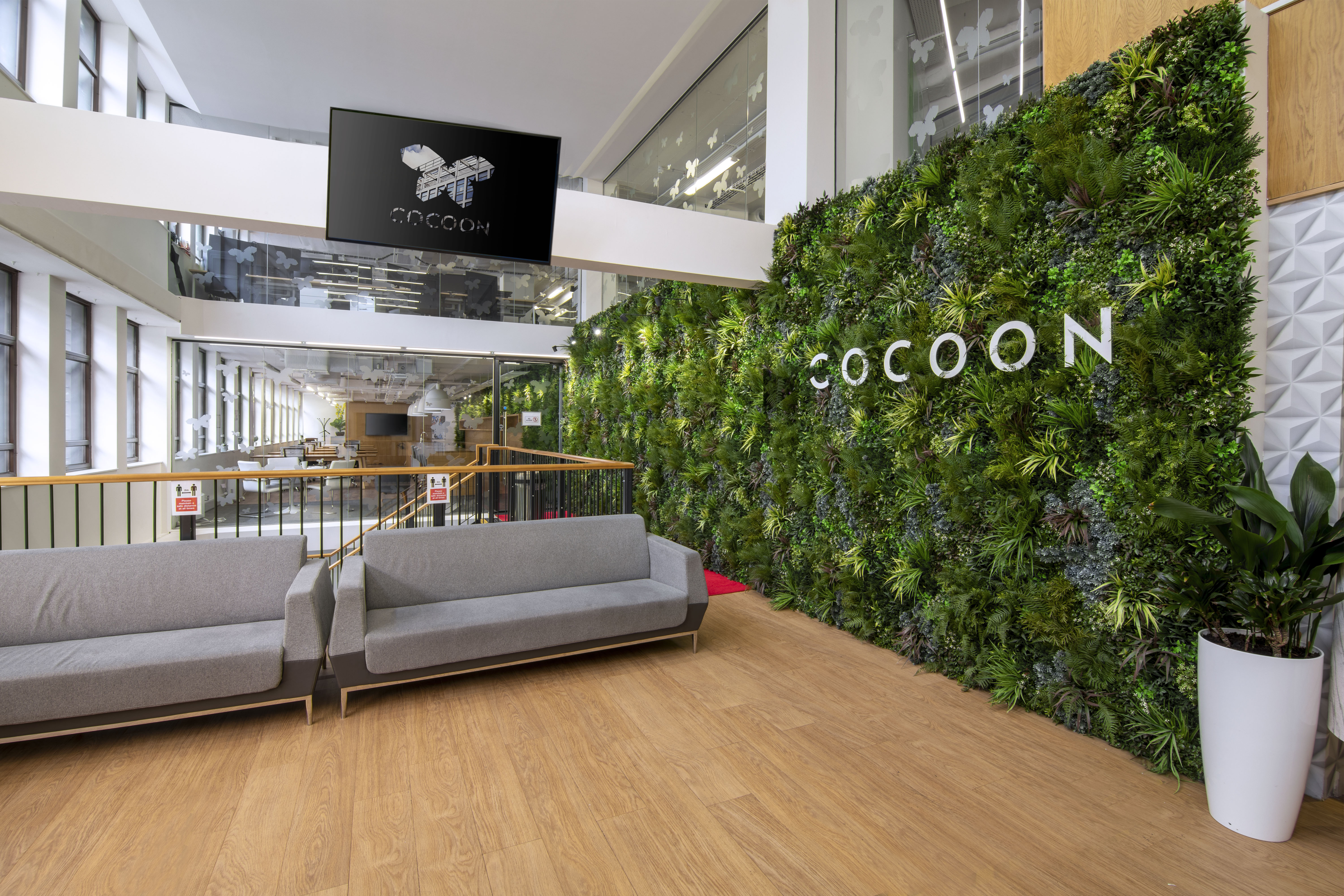 Modern reception area with vertical garden for creative events at Cocoon Space.