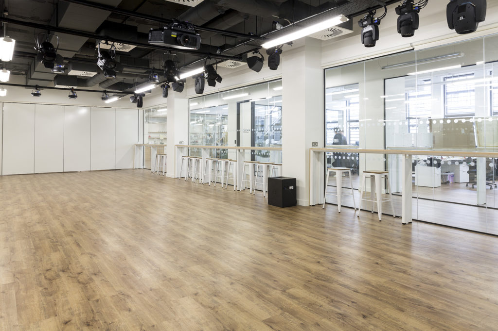 "Versatile Cocoon Space meeting room with polished wood floors for corporate events and workshops."