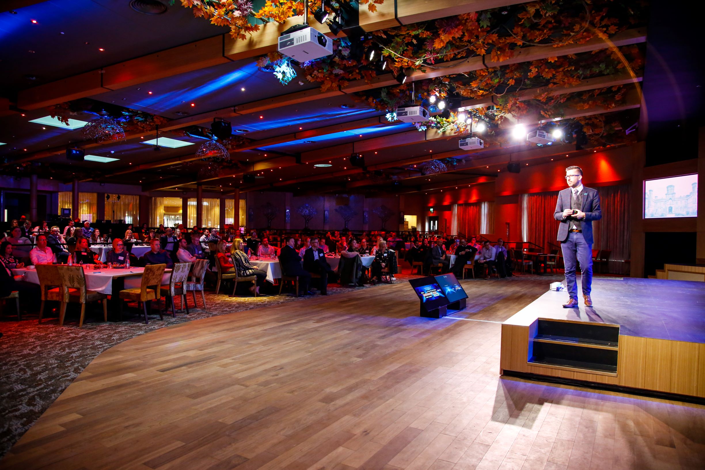 Elegant event space at Studley Castle with speaker addressing engaged audience. Conference setup.