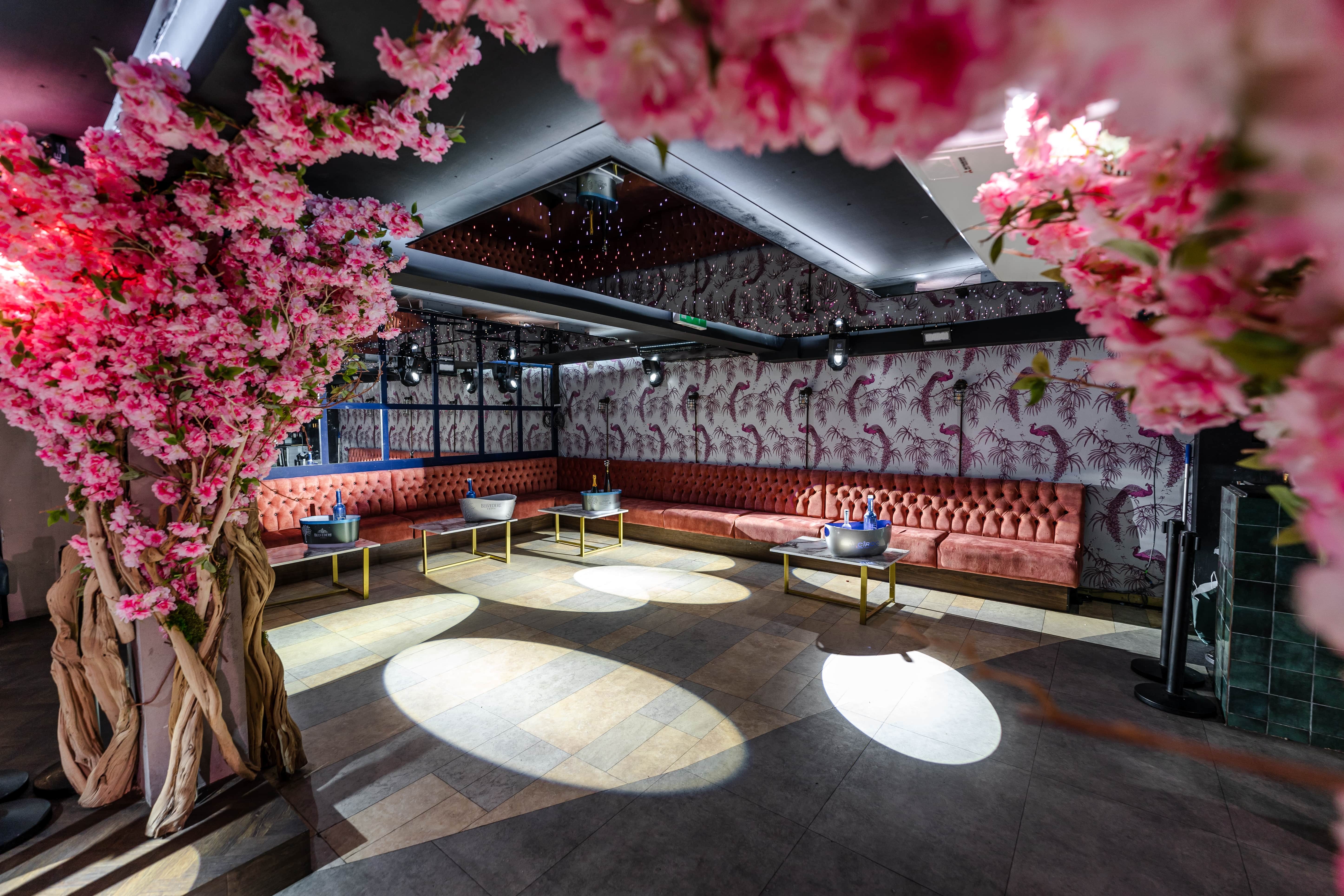 Elegant event space at The Club in Chelsea Lodge with cherry blossom decor for upscale gatherings.