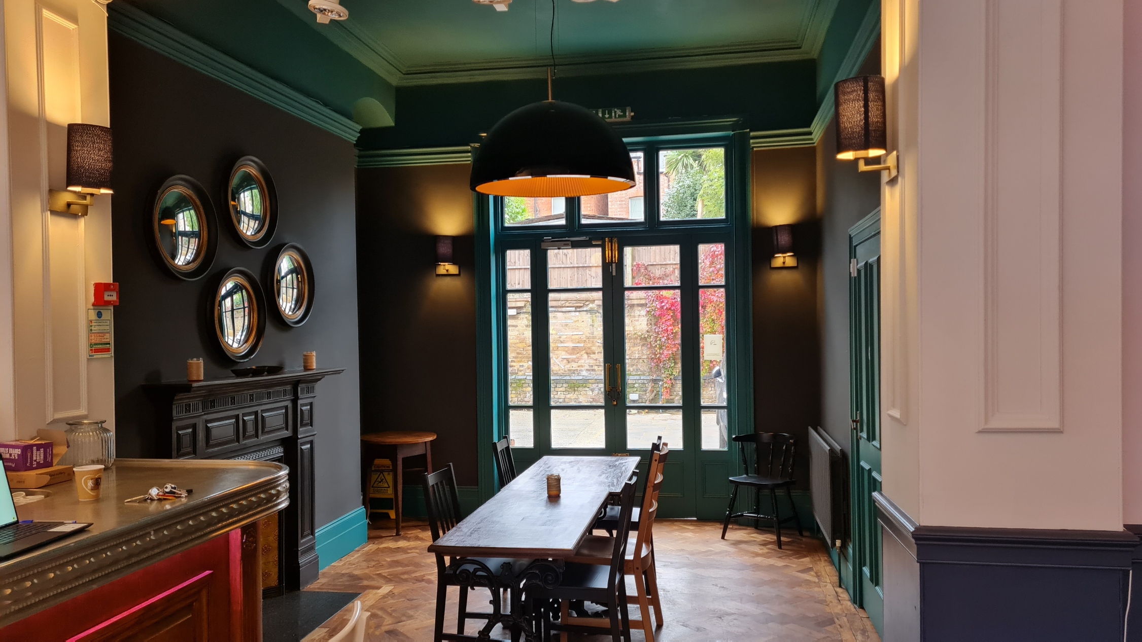 Stylish meeting space at The Windmill Bar with natural light, ideal for gatherings.