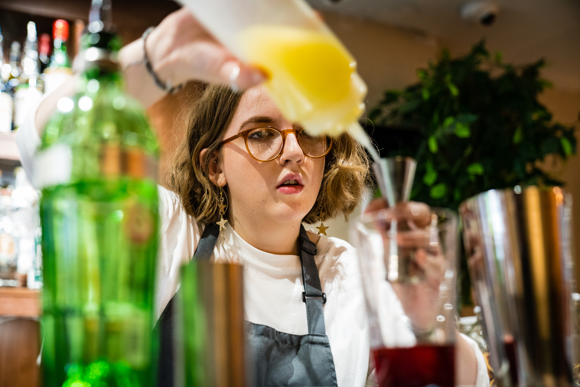 Skilled bartender mixing drinks at BoBo venue for memorable event experiences.