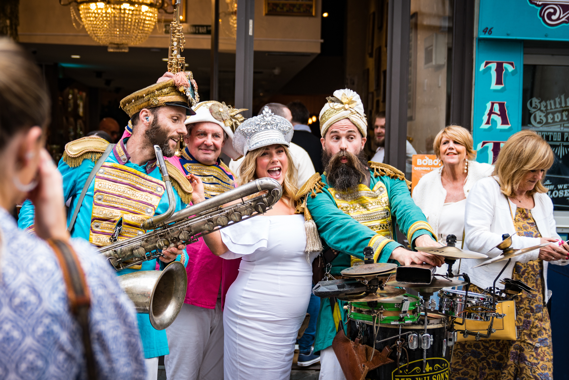 Vibrant performers in colorful costumes at a lively event venue for celebrations.
