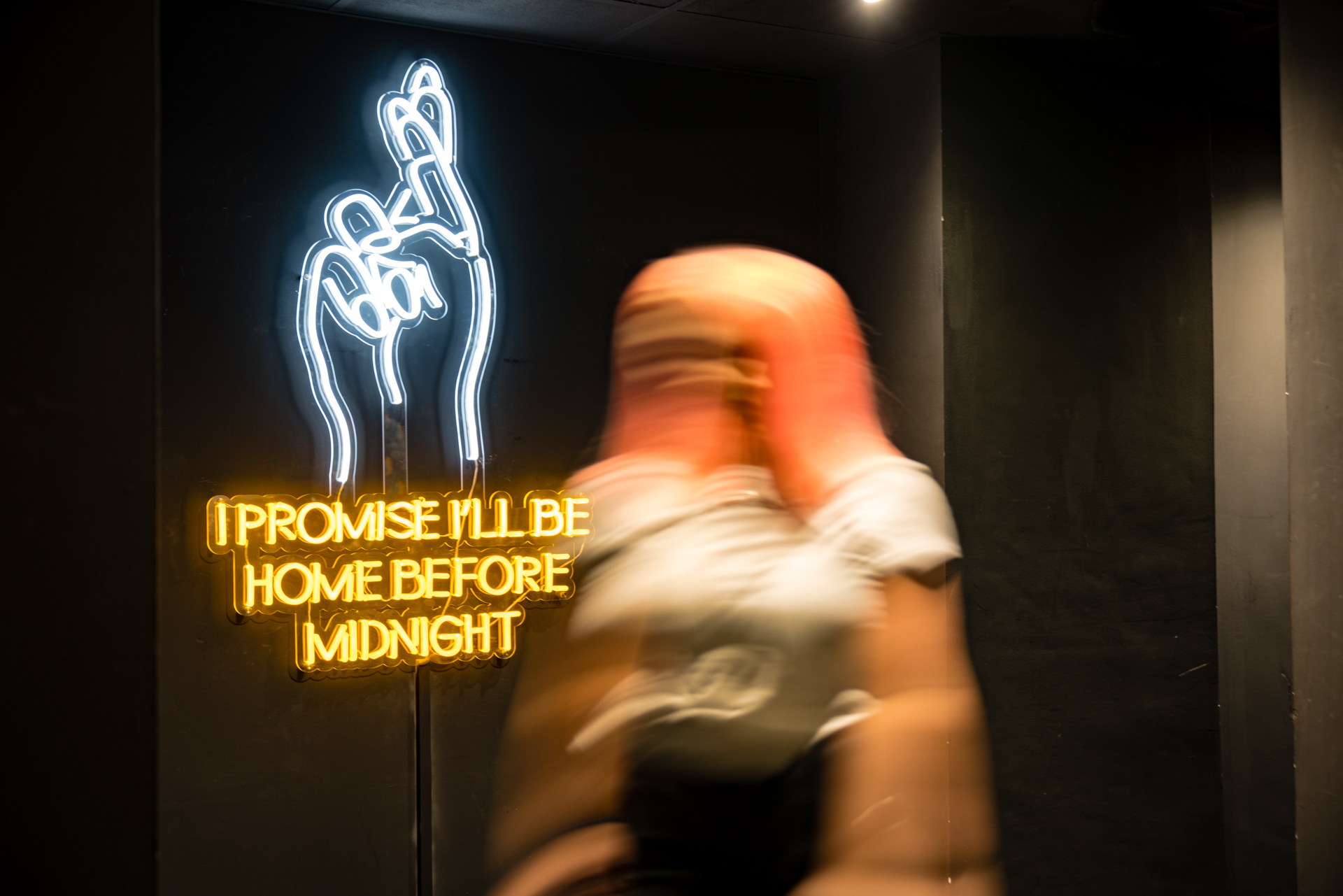 Vibrant event space in BoBo with neon sign, perfect for nightlife and social gatherings.